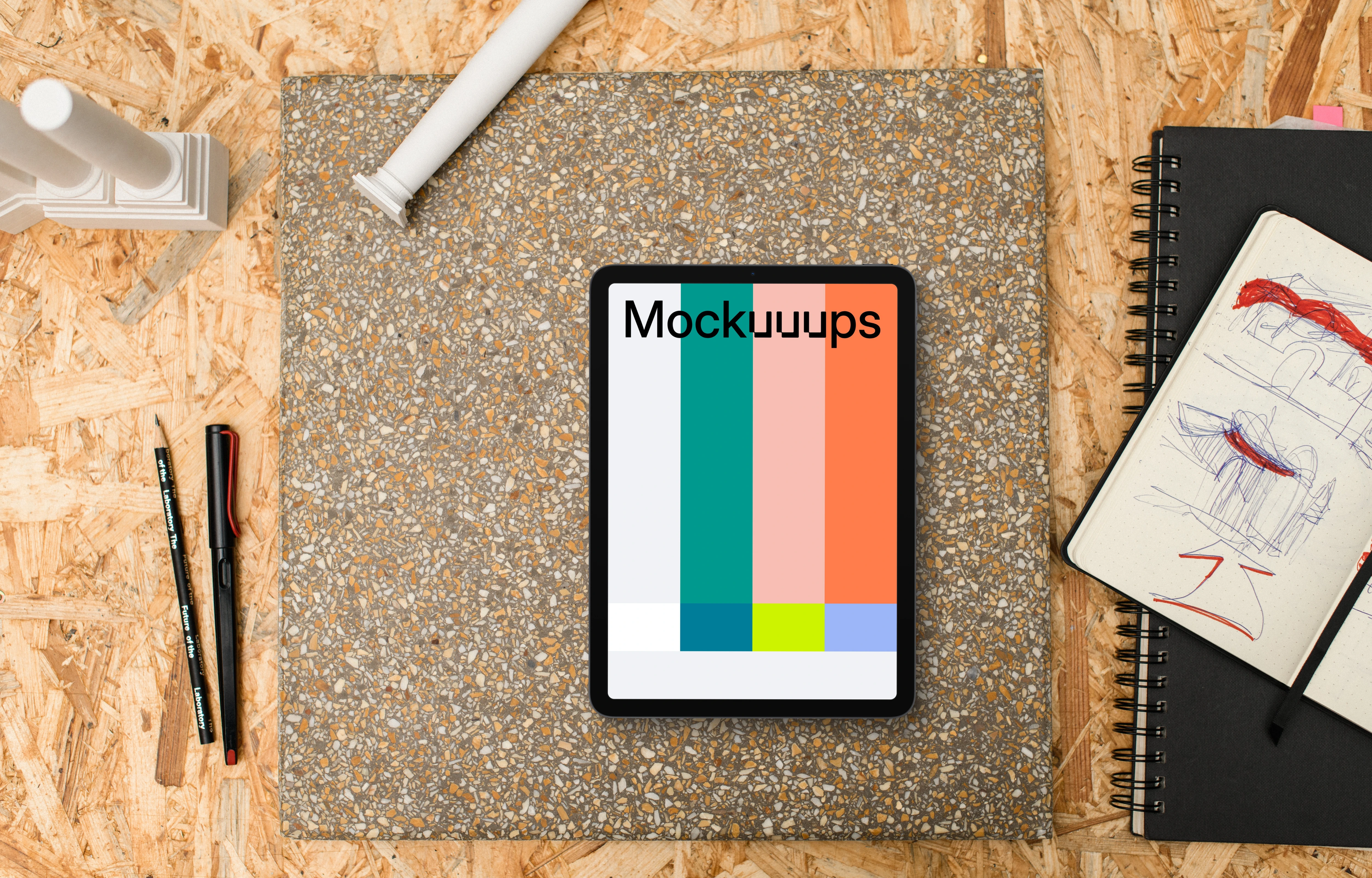 Tablet mockup surrounded by architectural drawing materials