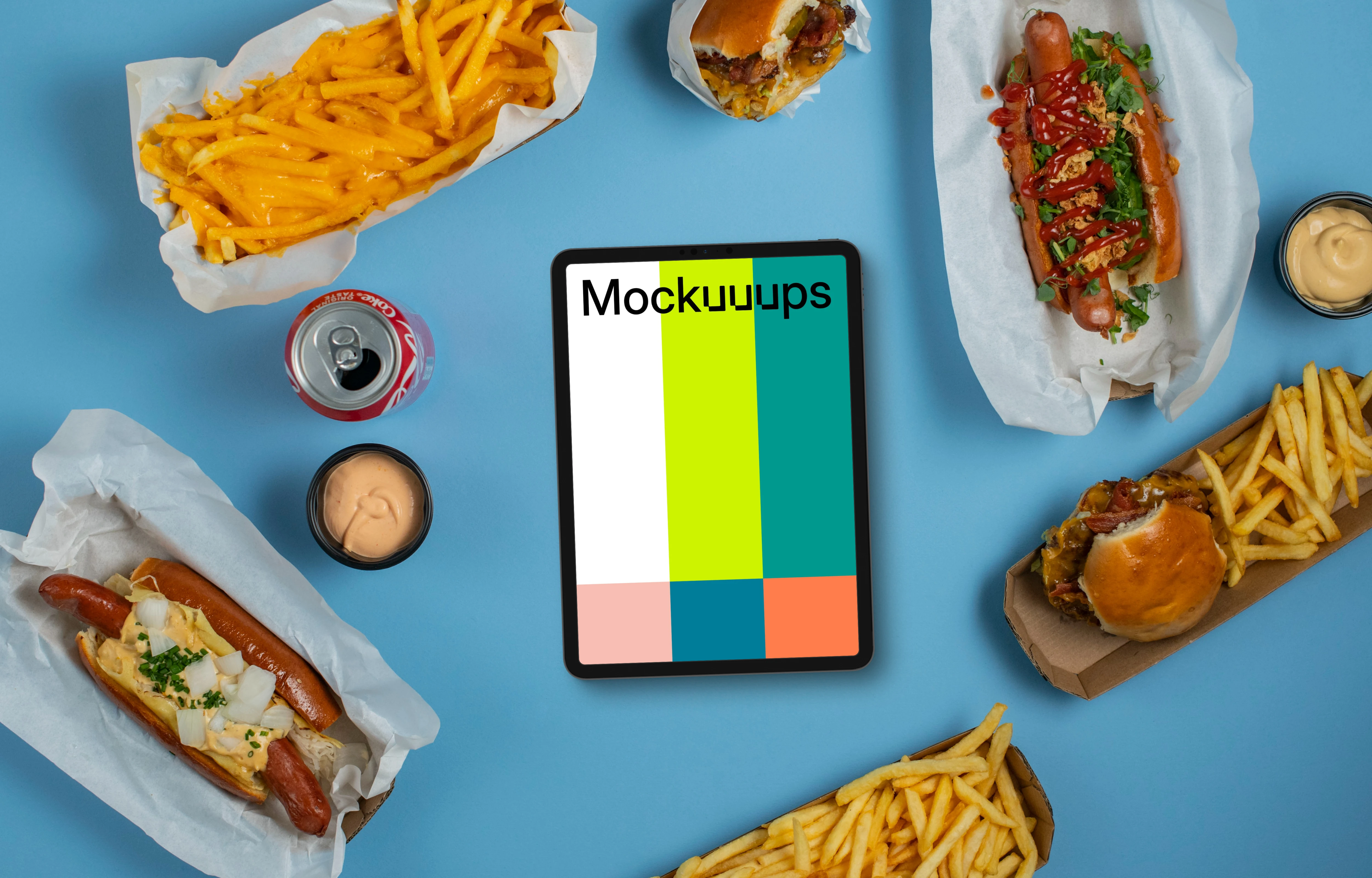 Tablet mockup surrounded by hot-dogs and fries