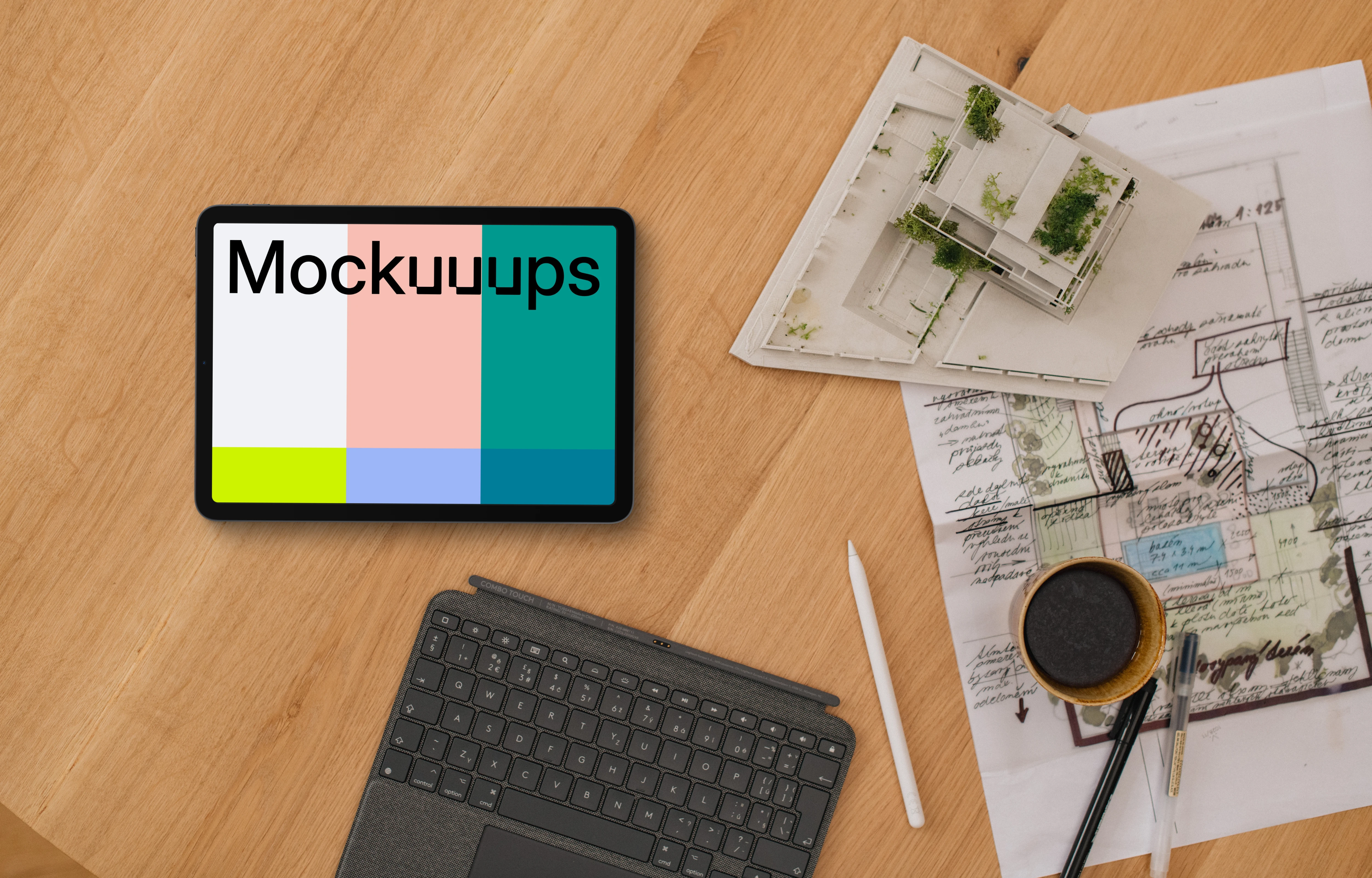 Tablet mockup with architect plans and coffee