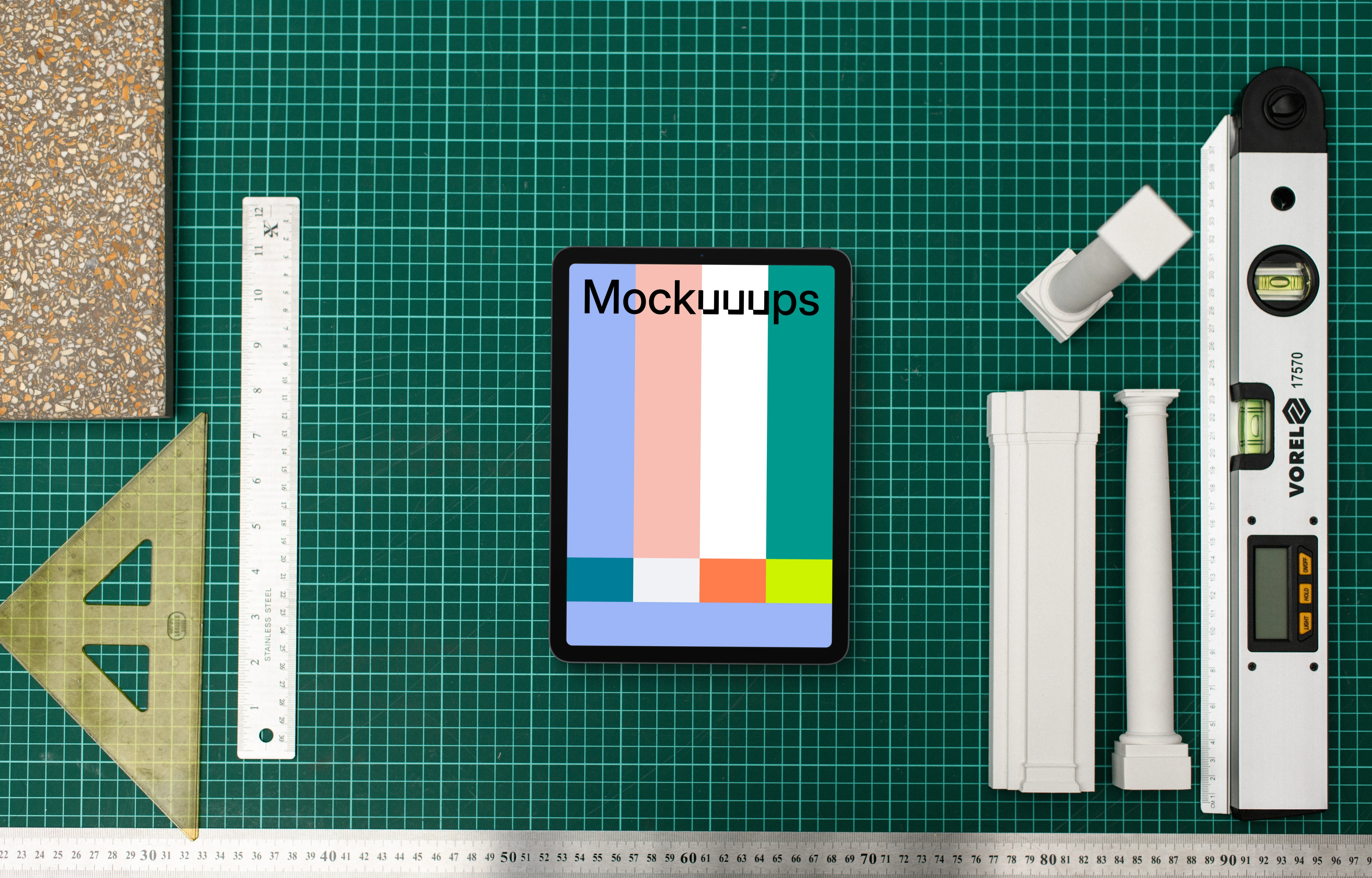 Tablet mockup with architect's tools on drafting table