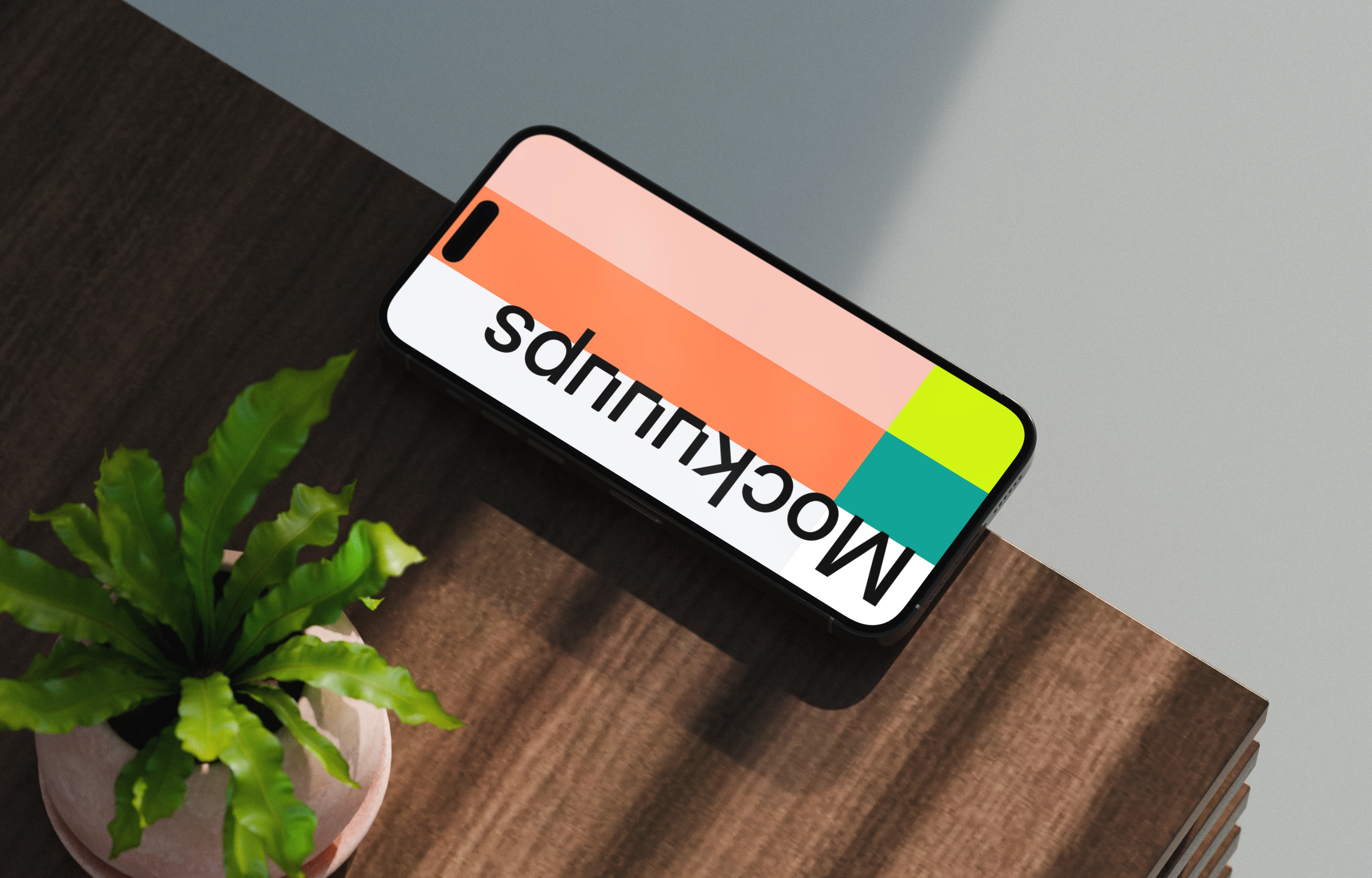 iPhone 17 mockup on a wooden desk with a plant
