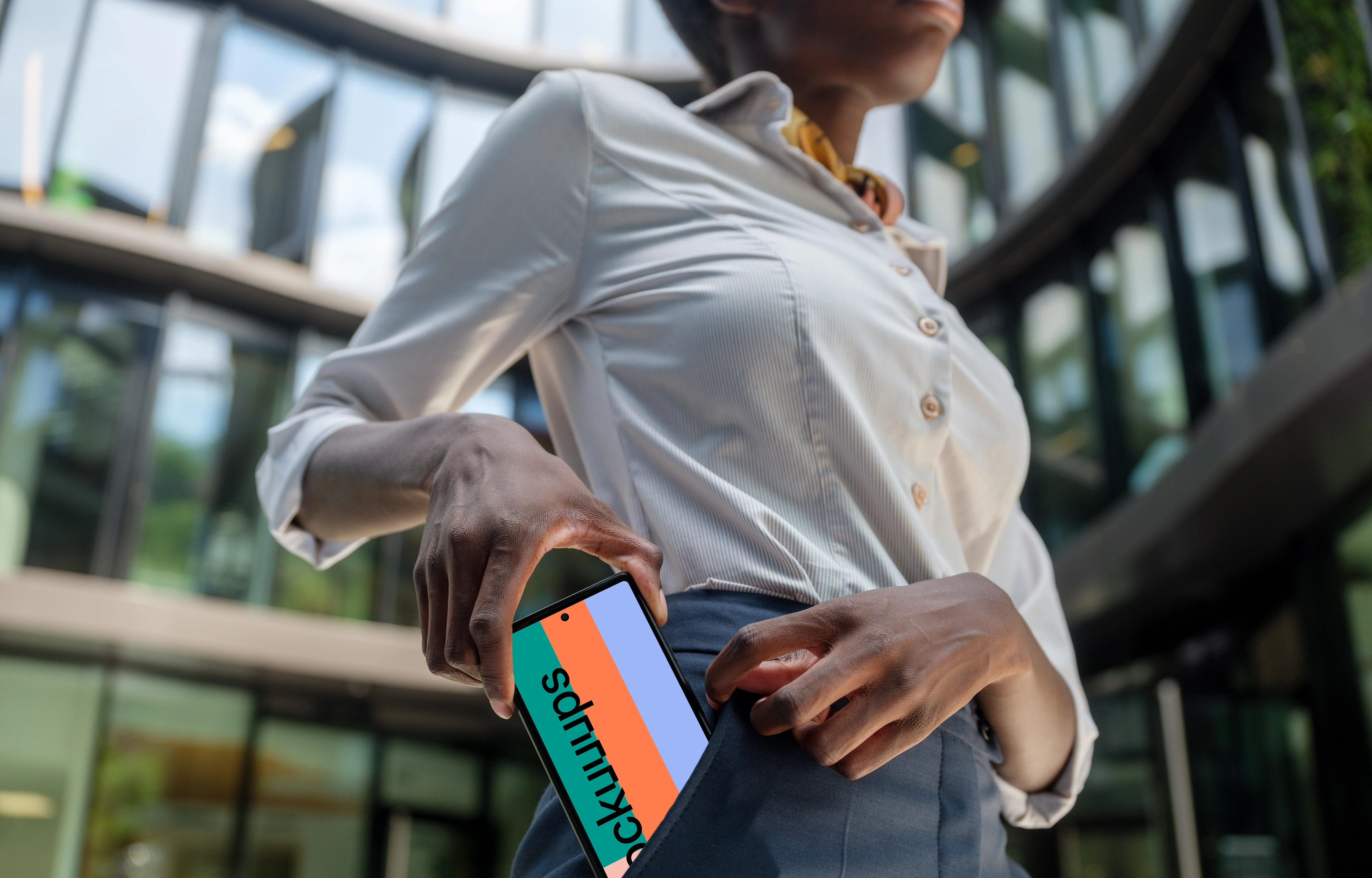 Businesswoman putting Google Pixel into her pocket