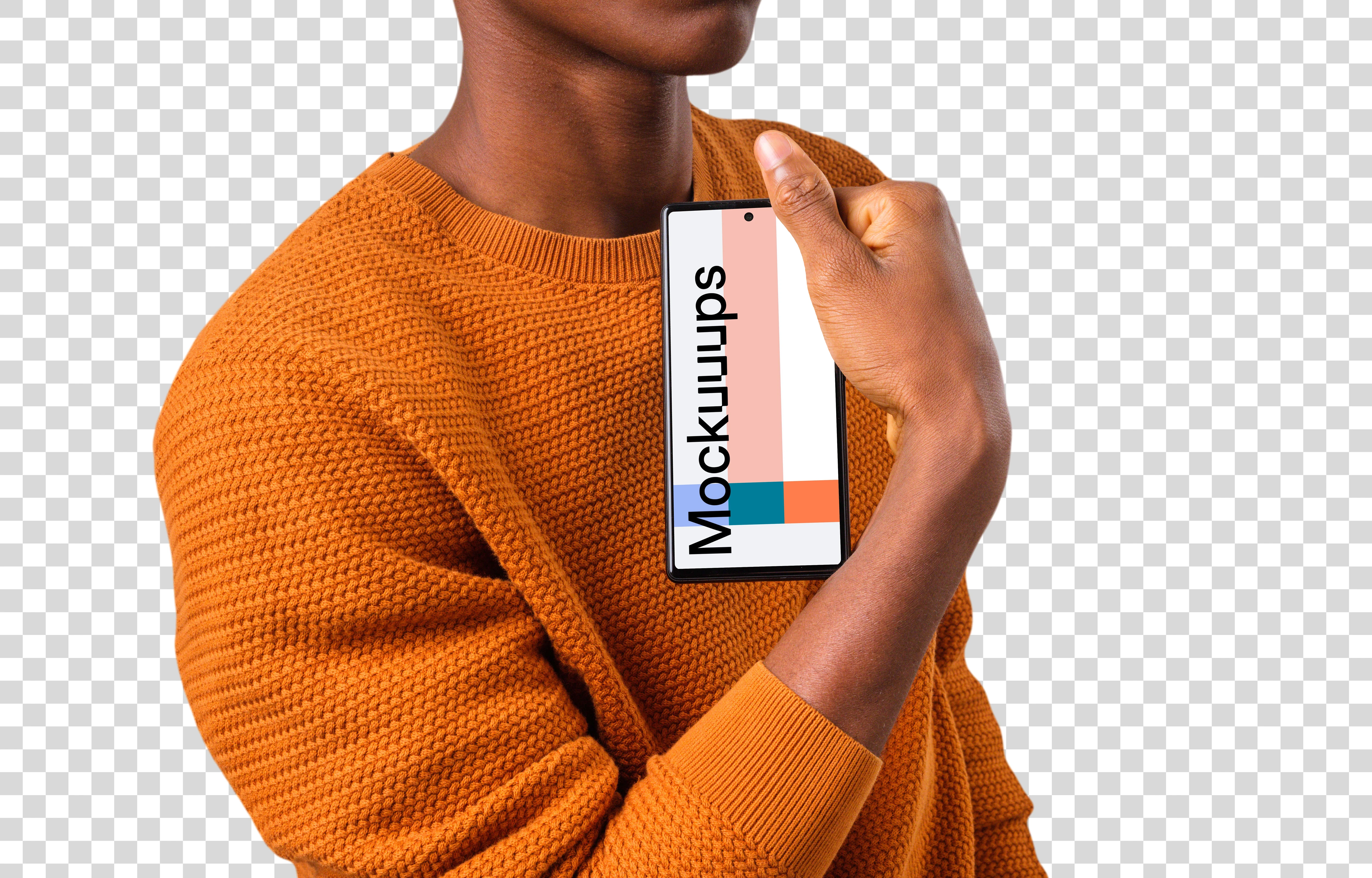 Man in orange sweater holding Google Pixel mockup in one hand