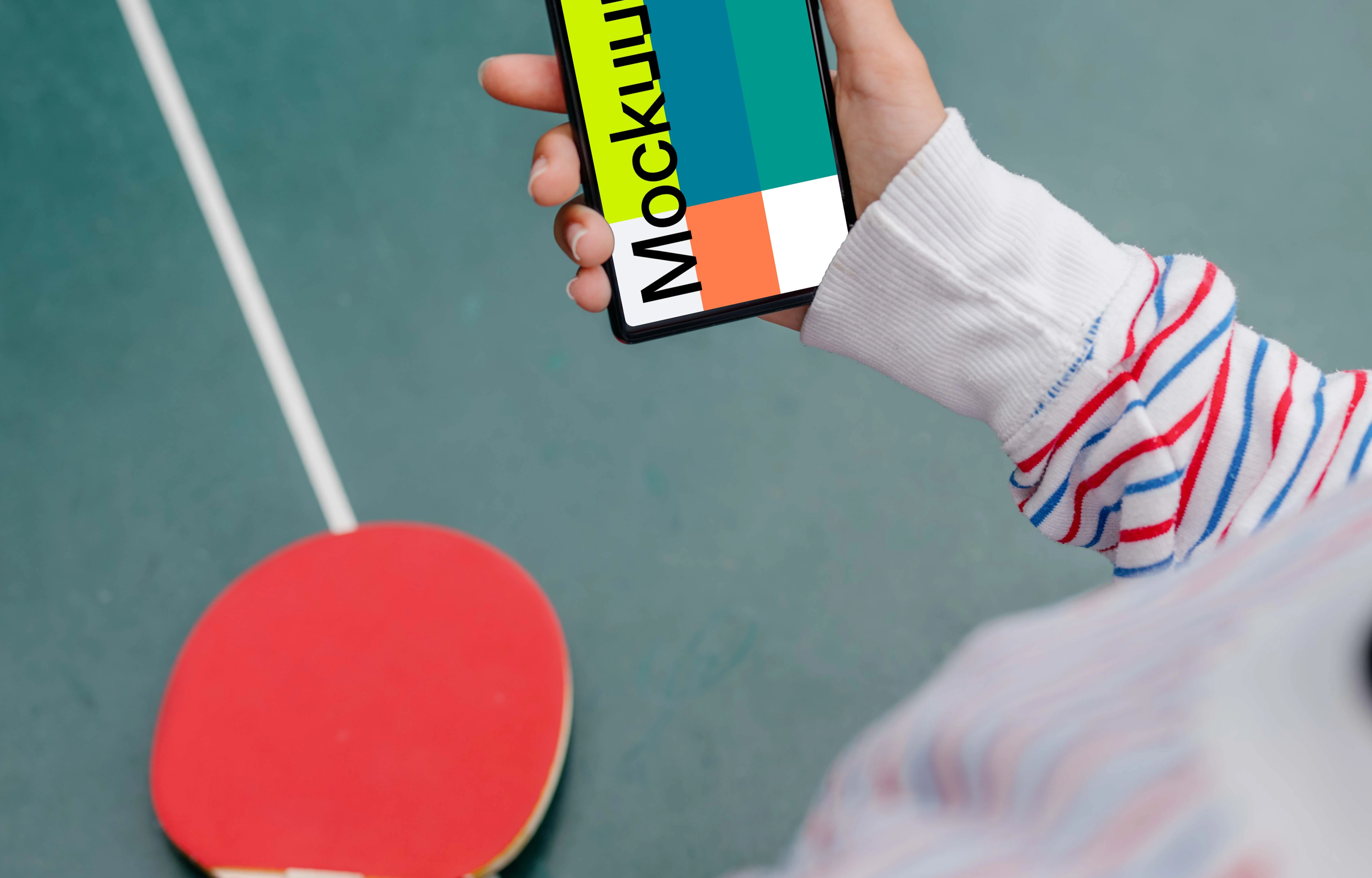 Woman hand holding a phone mockup while playing ping-pong