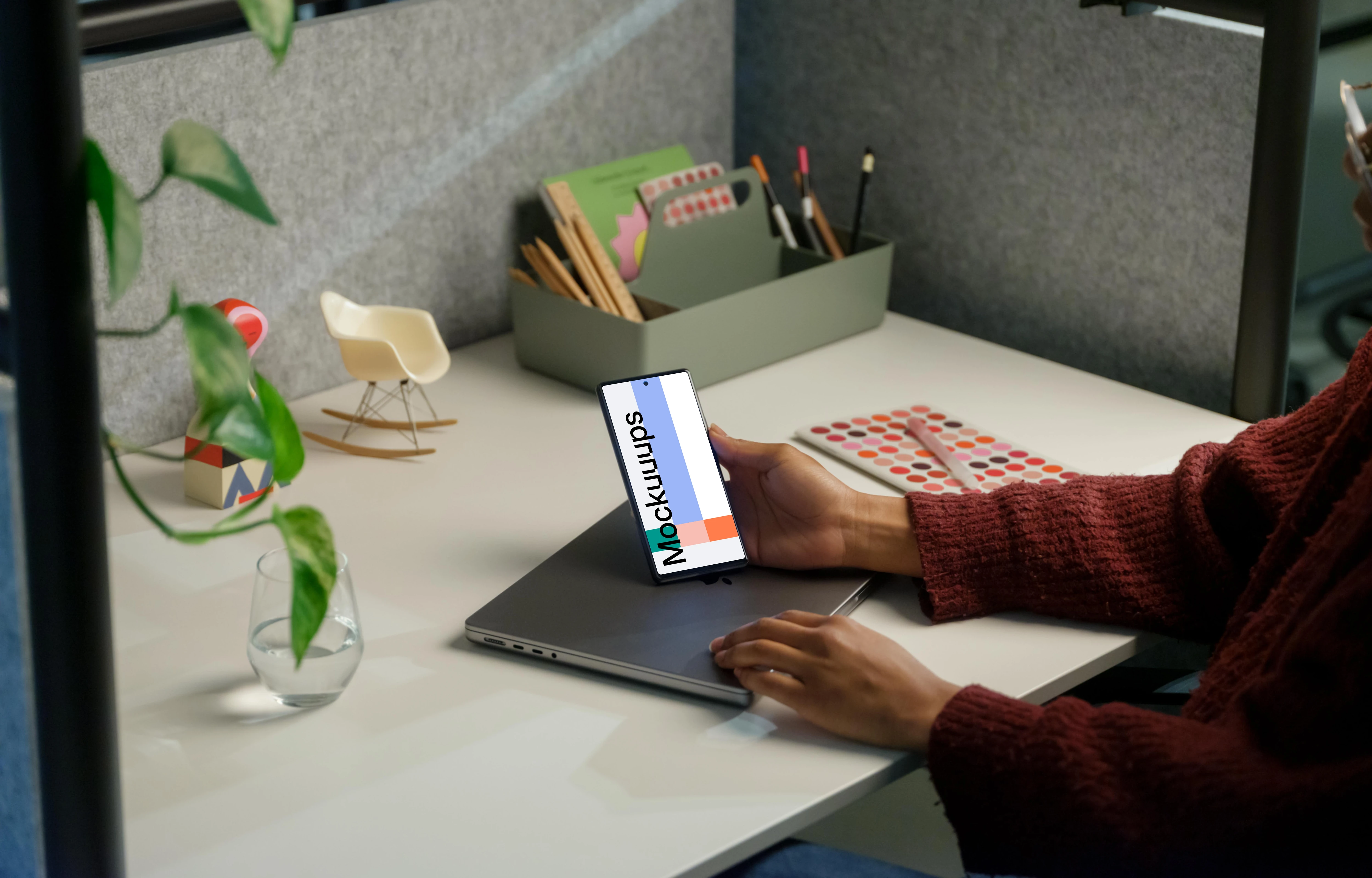 Woman holding a Google Pixel 6 mockup in office