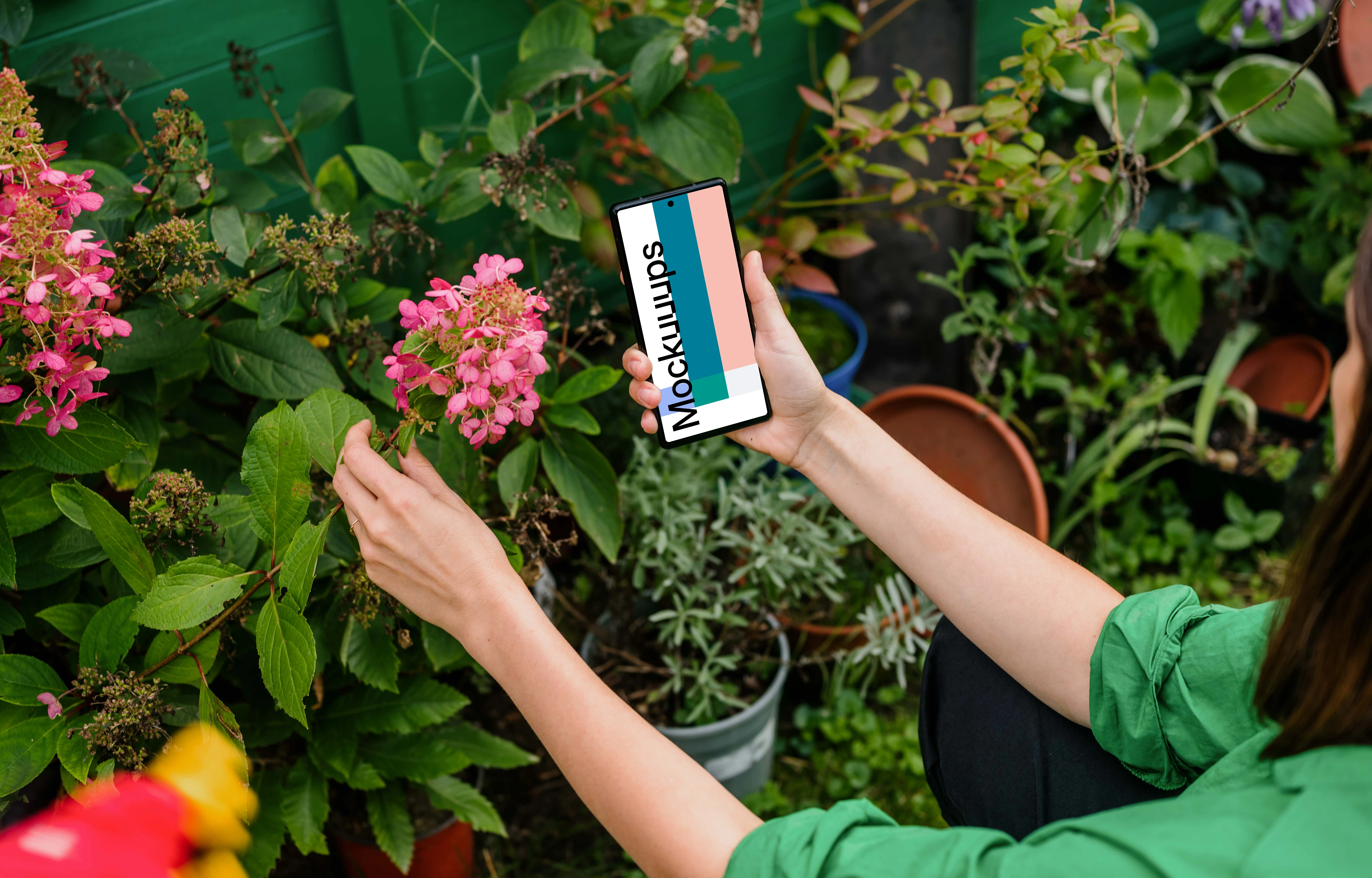 Woman holding a Google Pixel in garden mockup