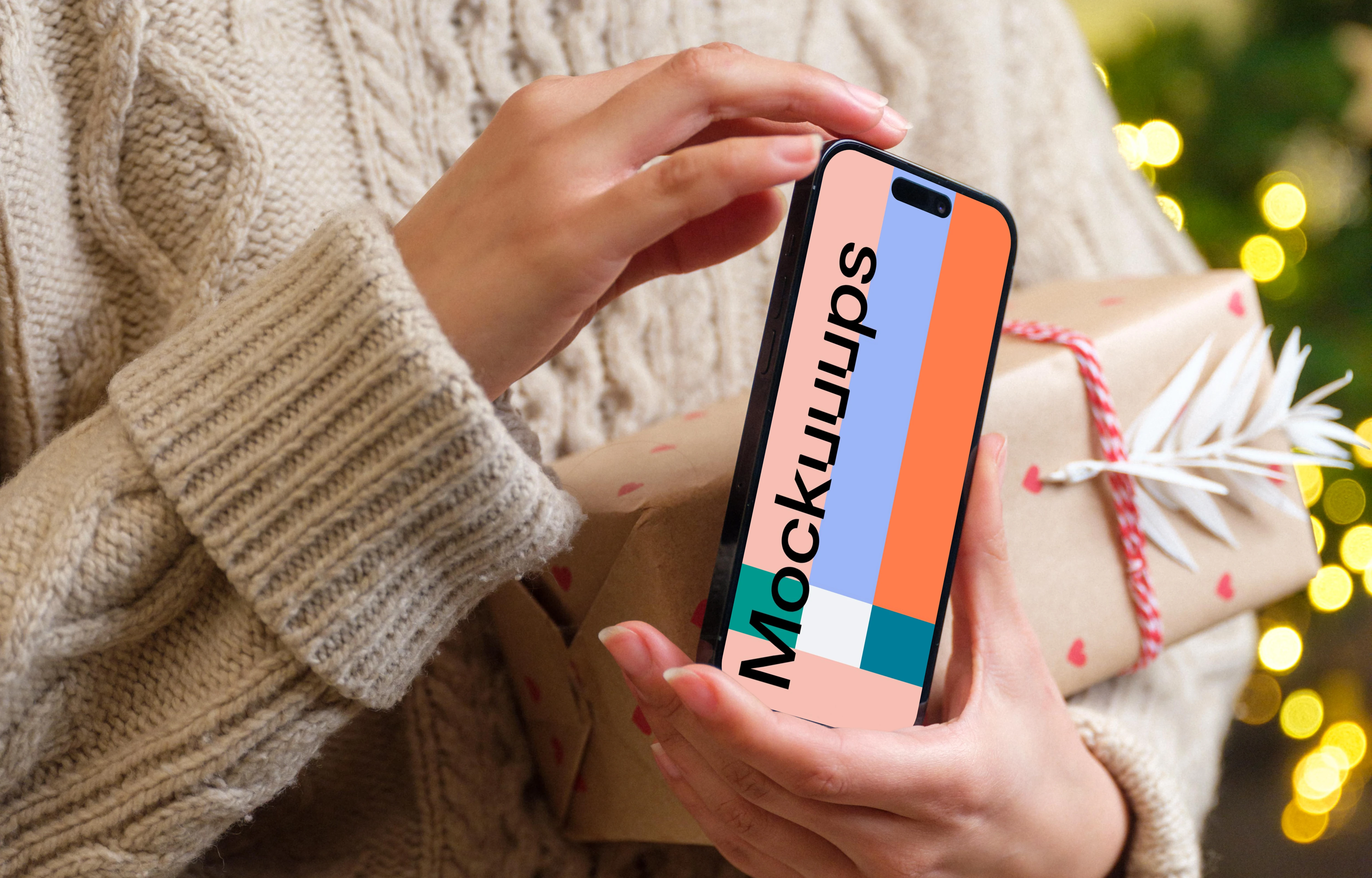 Woman holding a phone mockup in Christmas theme