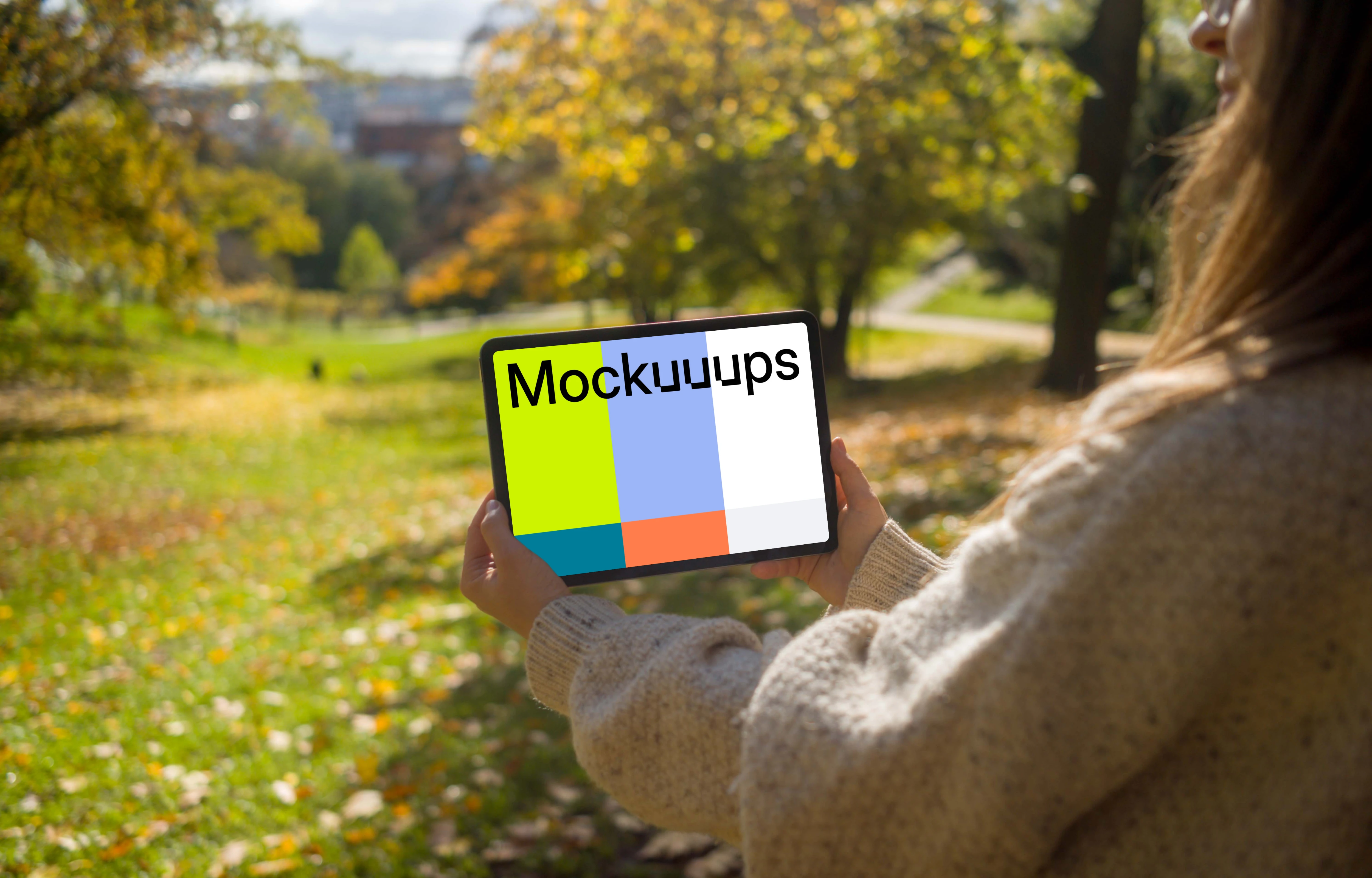 Woman holding a tablet in the garden mockup