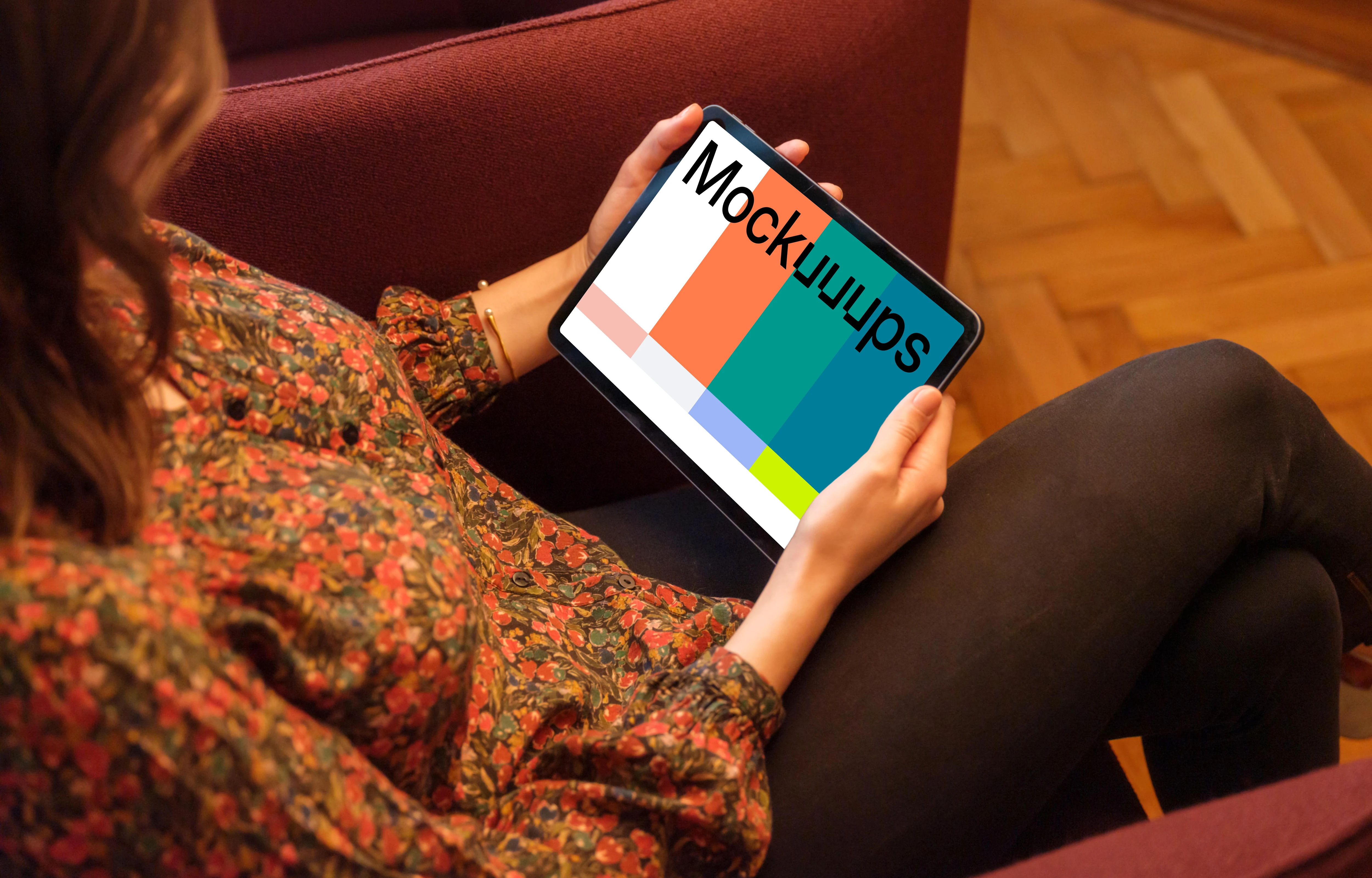 Woman holding a tablet mockup in the lounge