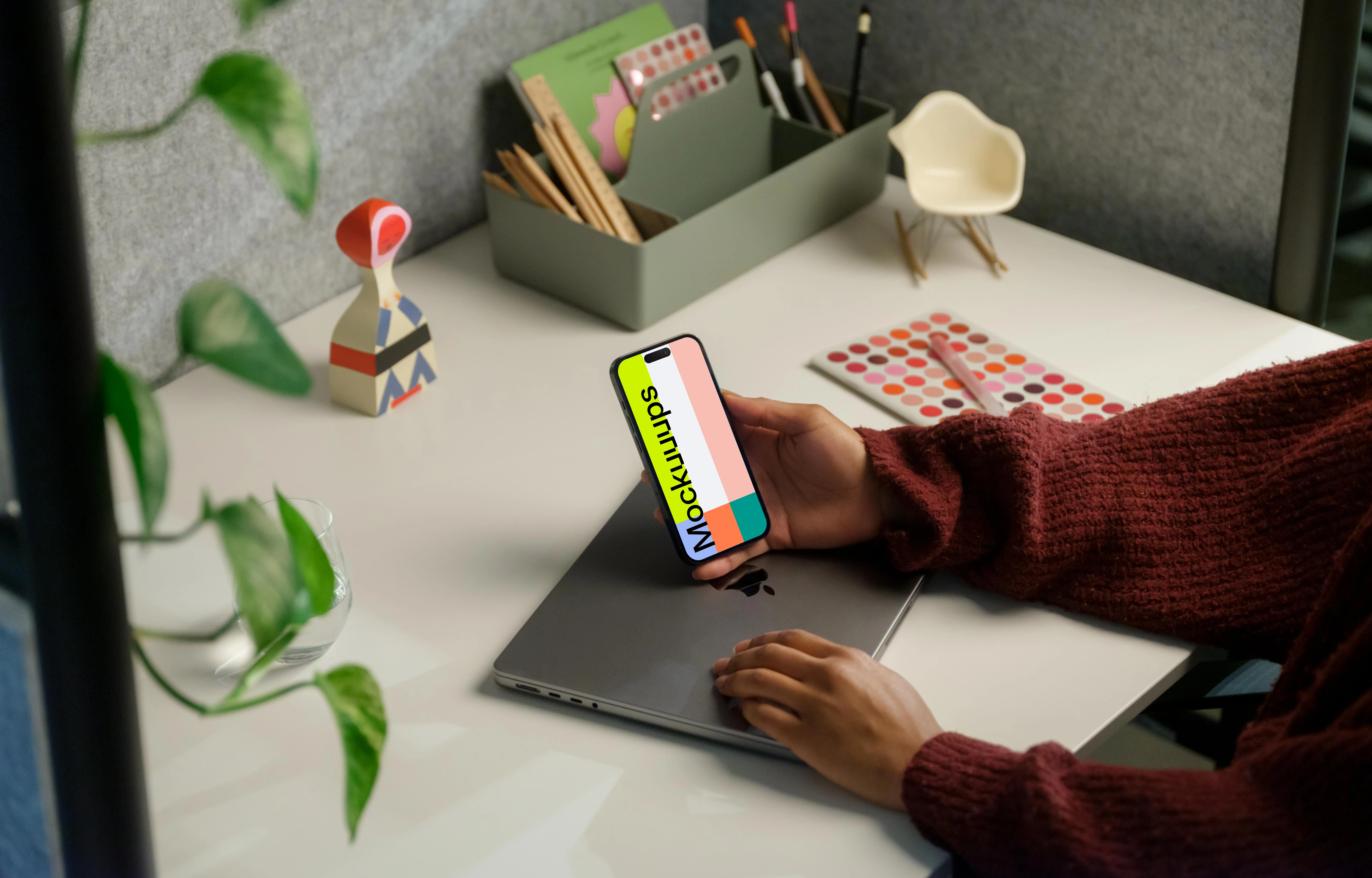 Free mockup of woman holding iPhone 14 Pro