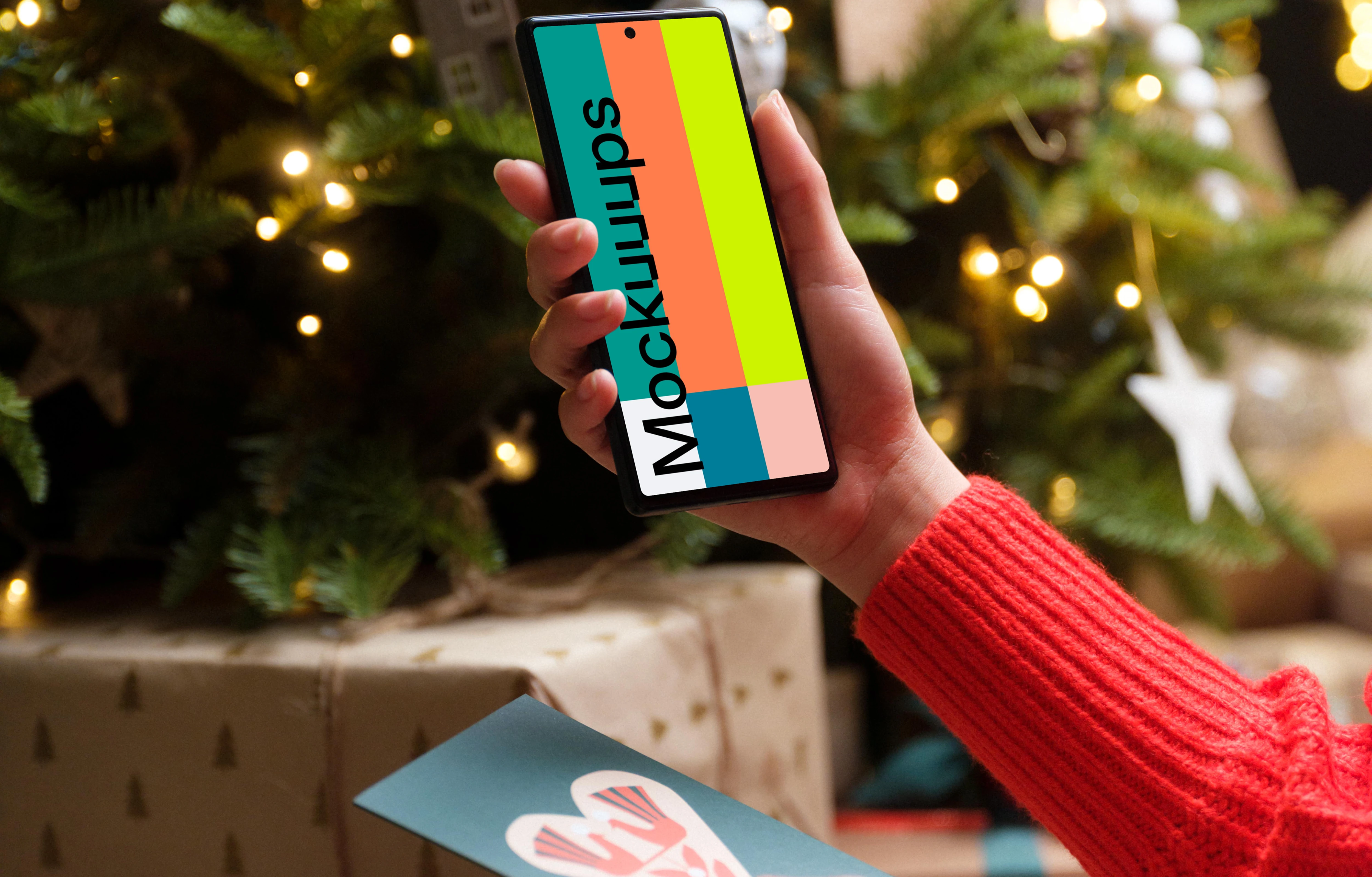 Woman in red sweater holding smartphone and gift card