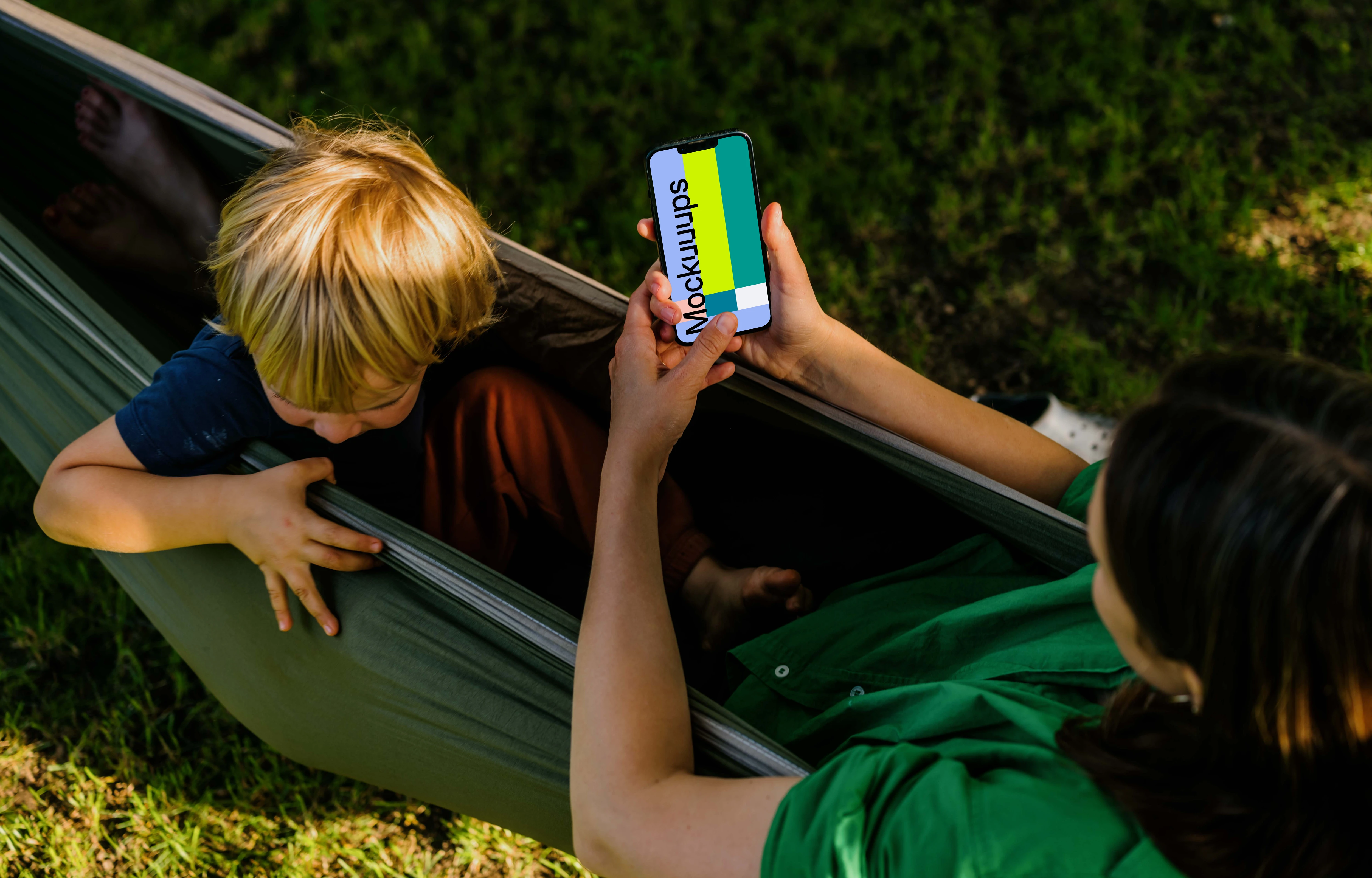 Woman laying in a hammock and typing on an iPhone 13 mockup