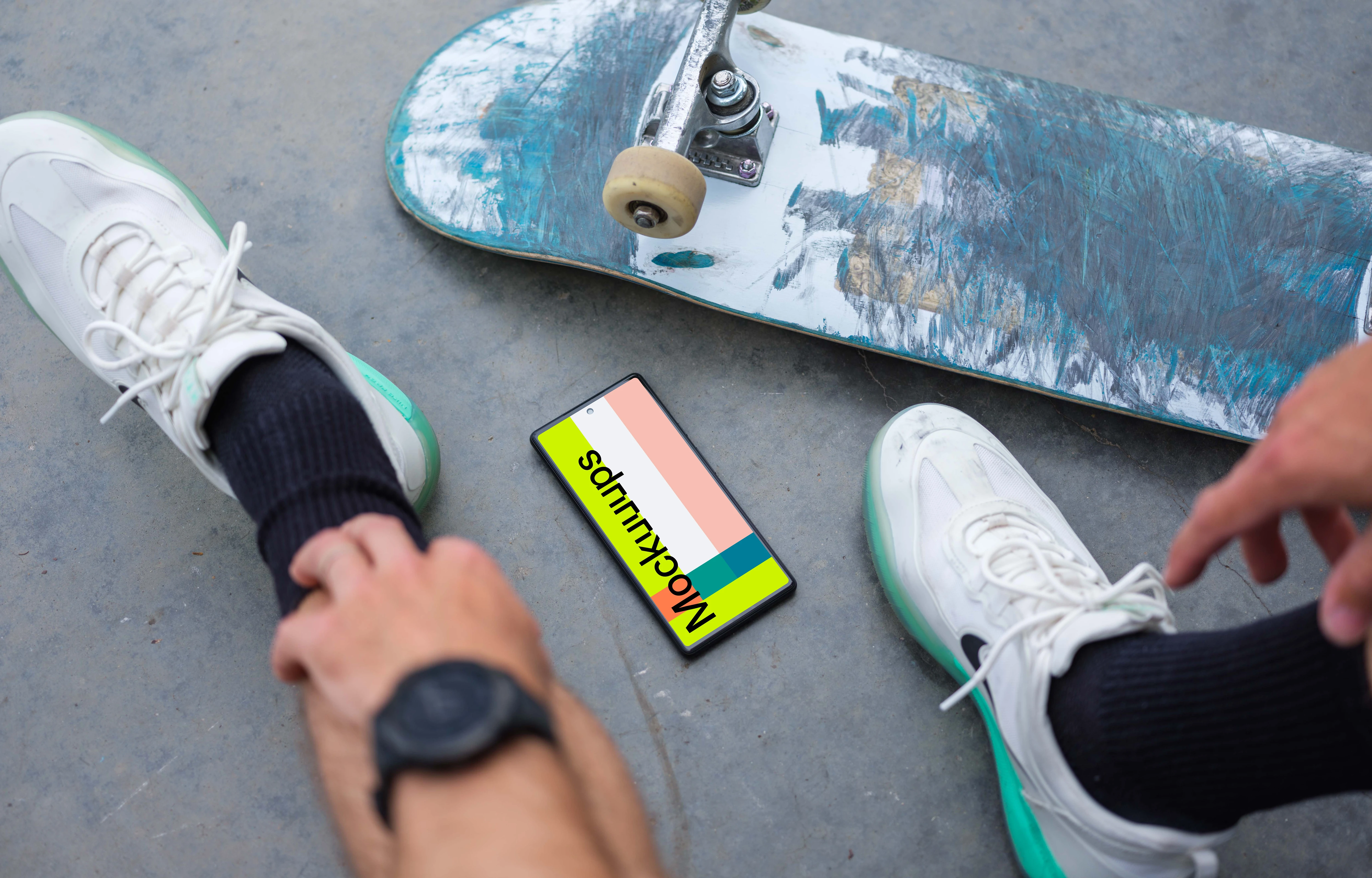 Skateboarder sitting next to a Google Pixel 6 mockup