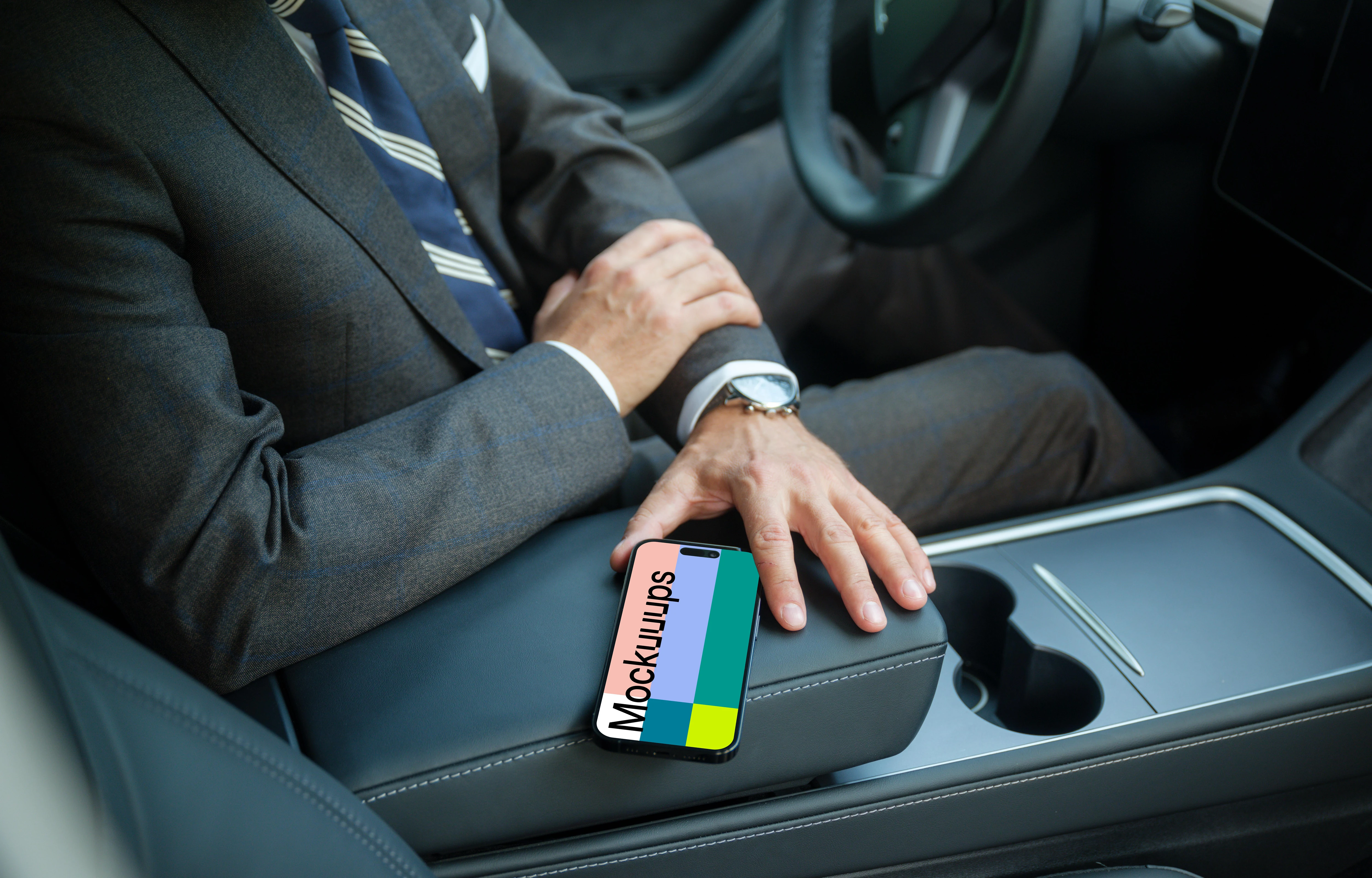 Entrepreneur sitting in Tesla with iPhone mockup