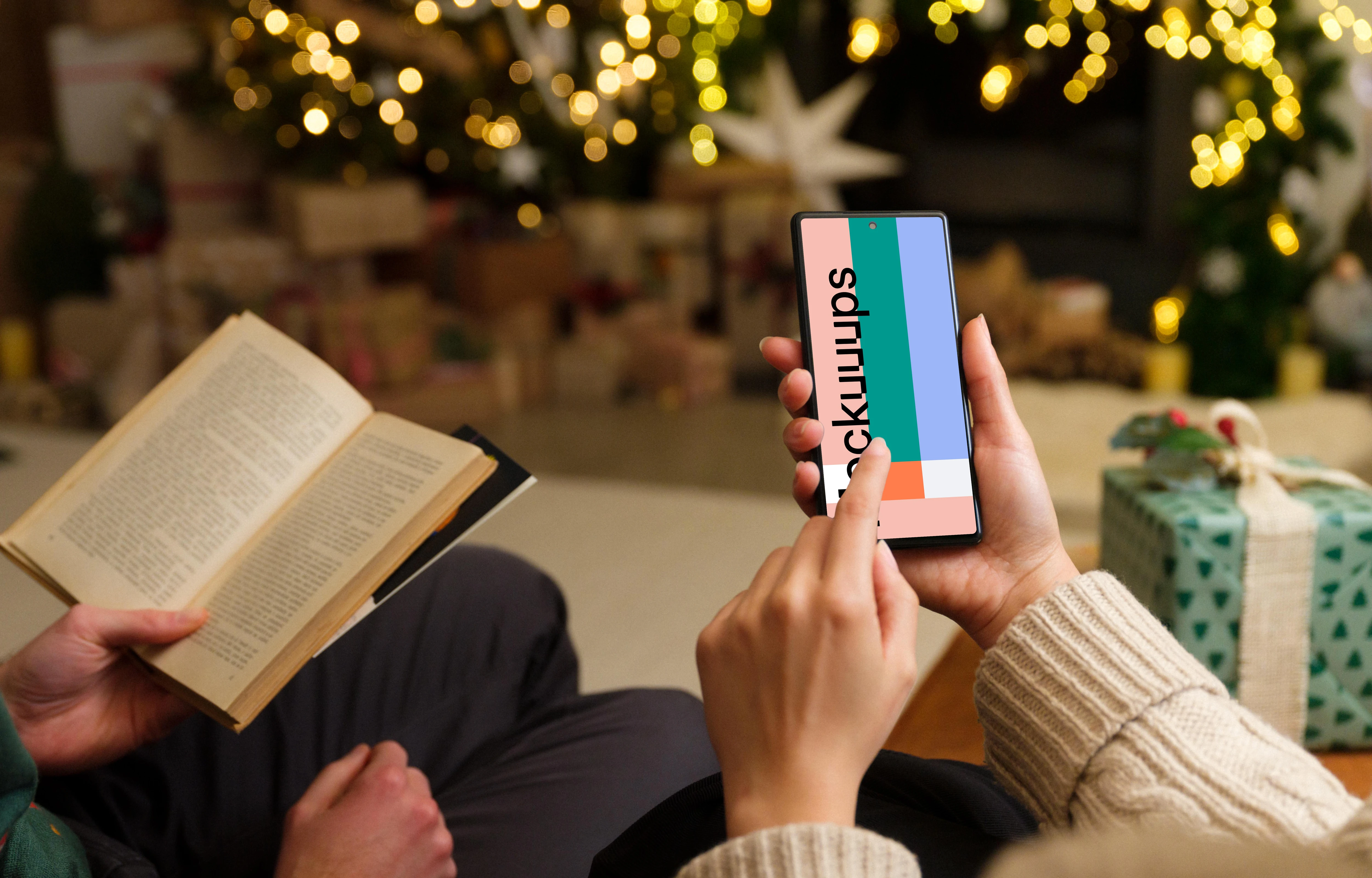 Hand typing on a phone mockup in Christmas theme