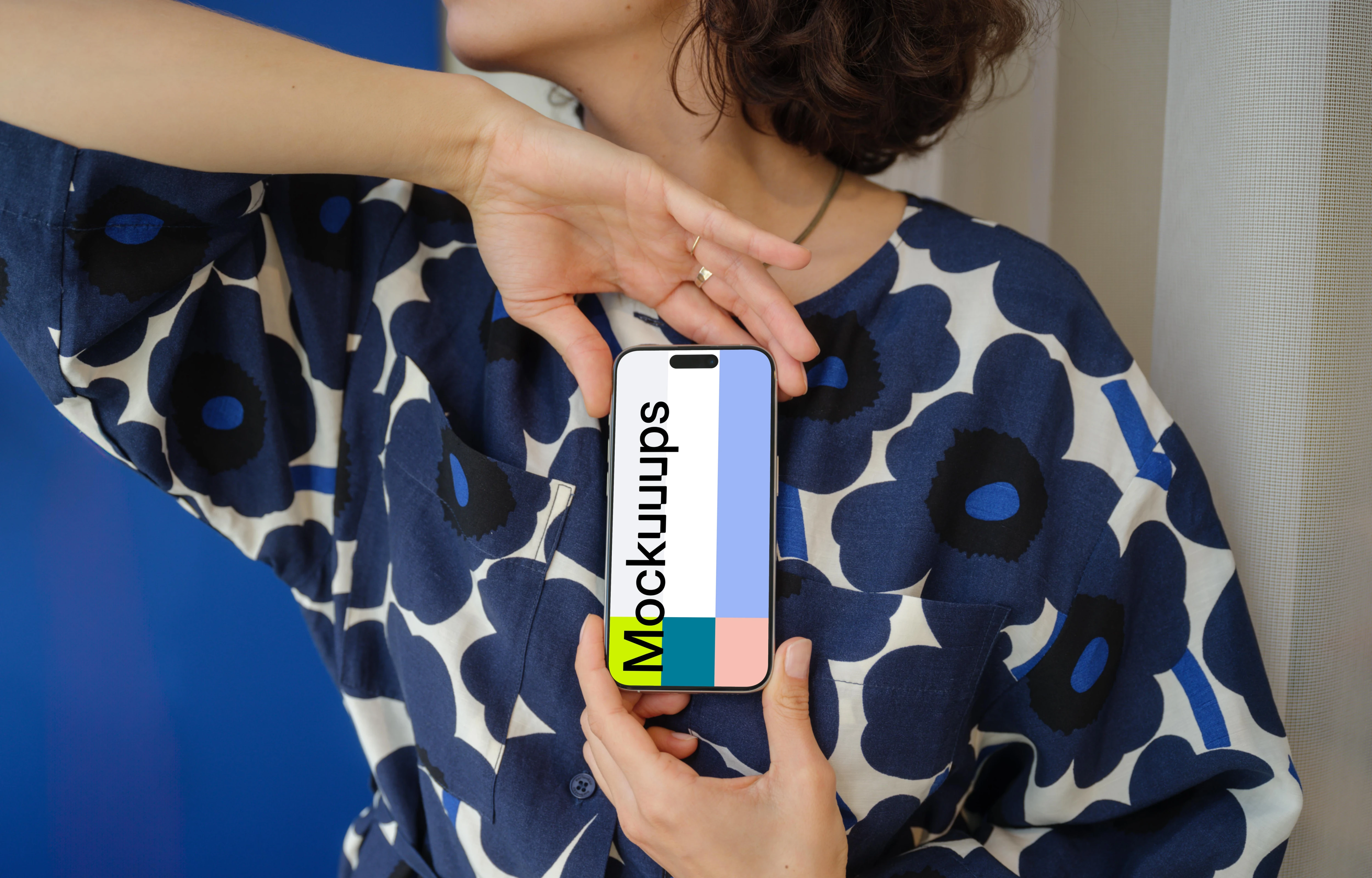 iPhone 15 Pro mockup in a woman's hand with floral outfit