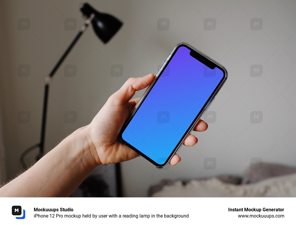 iPhone 12 Pro mockup held by user with a reading lamp in the background