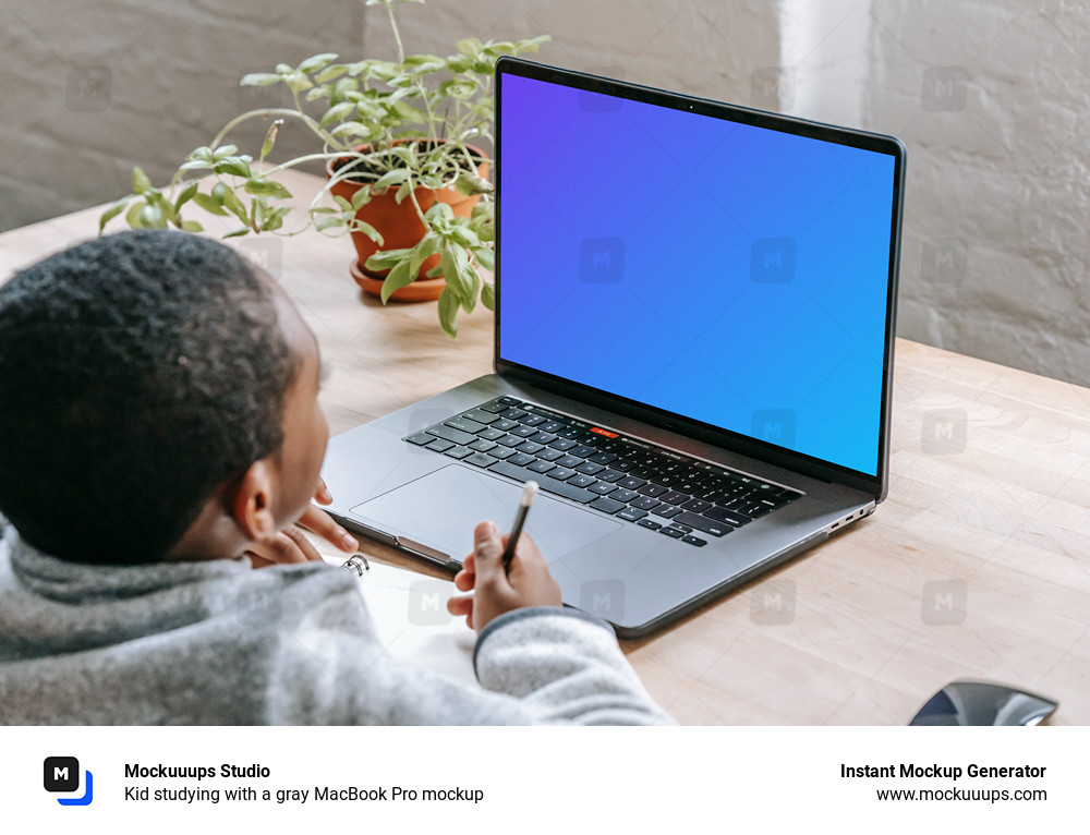 Kid studying with a gray MacBook Pro mockup