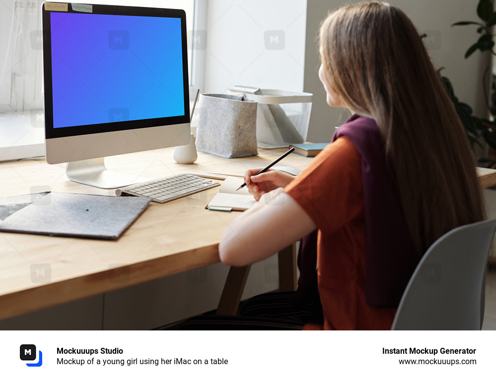 Mockup of a young girl using her iMac on a table