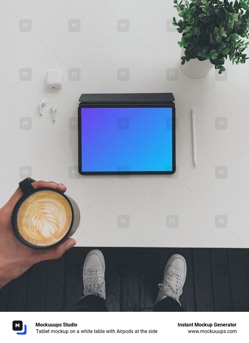 Tablet mockup on a white table with Airpods at the side