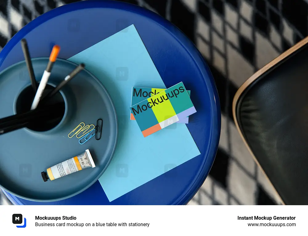 Business card mockup on a blue table with stationery
