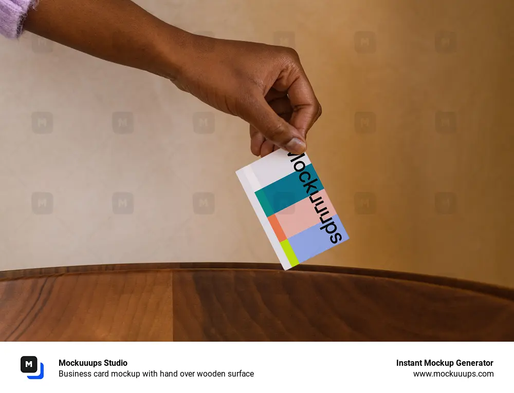 Business card mockup with hand over wooden surface