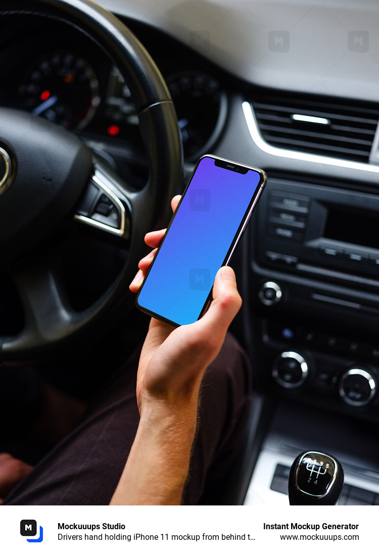 Drivers hand holding iPhone 11 mockup from behind the wheel