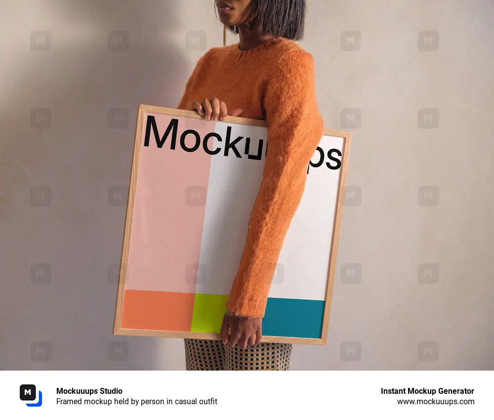 Framed mockup held by person in casual outfit