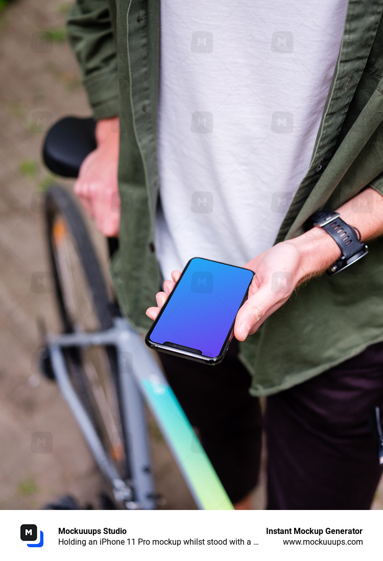 Holding an iPhone 11 Pro mockup whilst stood with a bike