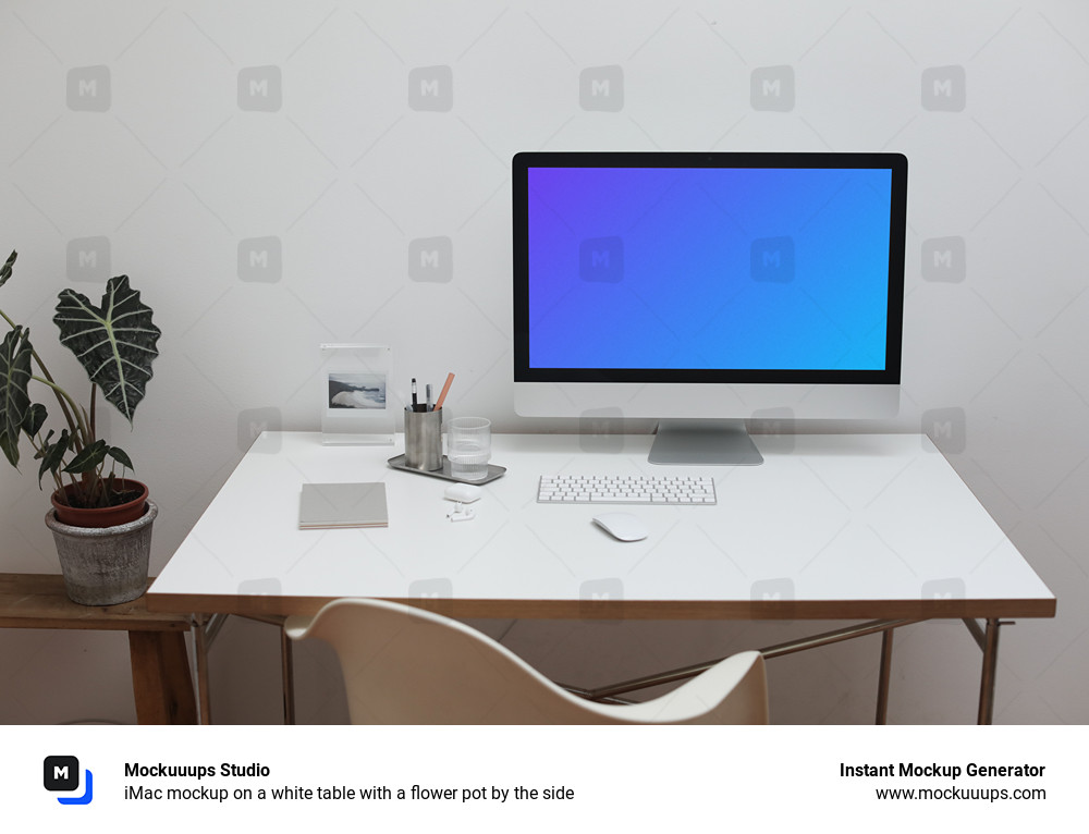 iMac mockup on a white table with a flower pot by the side