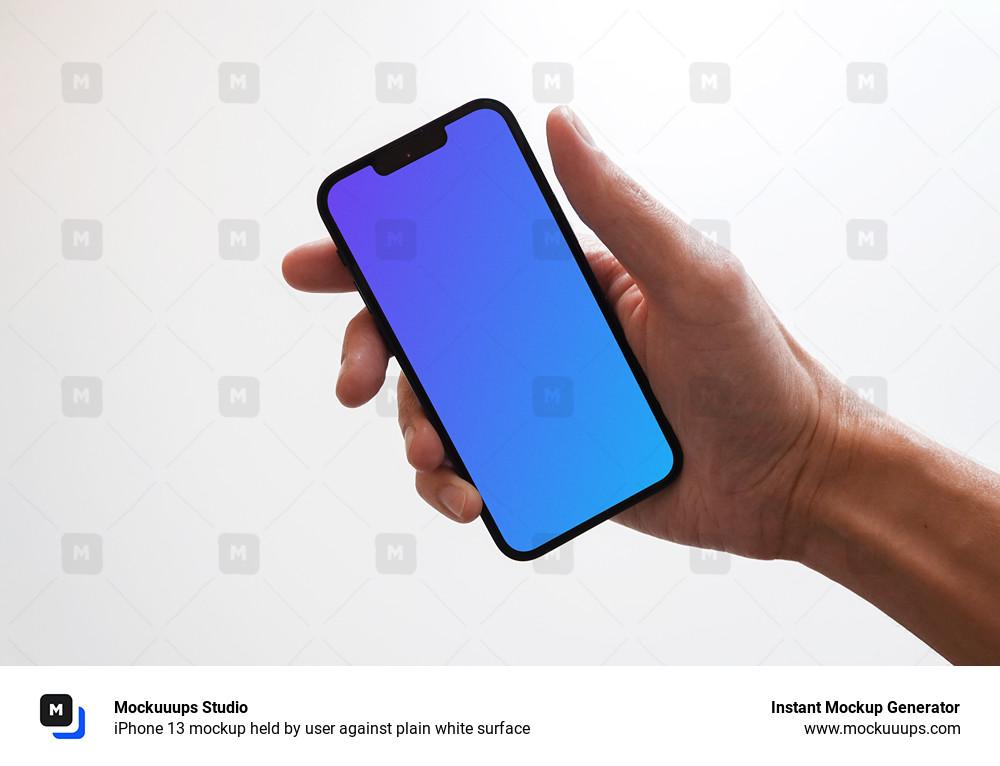 iPhone 13 mockup held by user against plain white surface