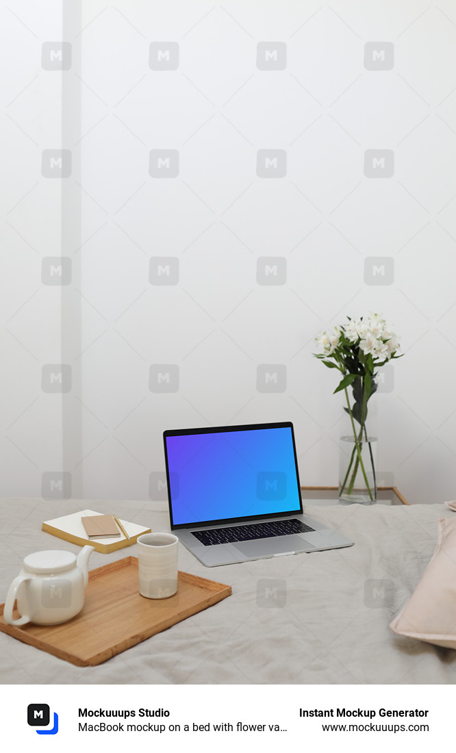 MacBook mockup on a bed with flower vase in the background