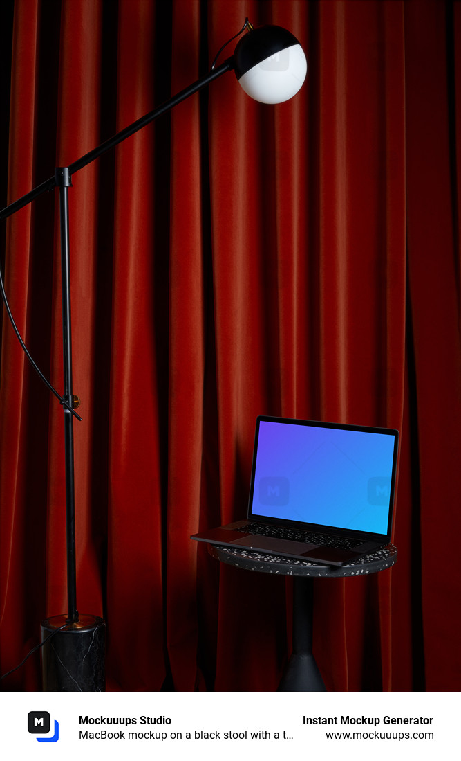 MacBook mockup on a black stool with a tall lamp hanging above it