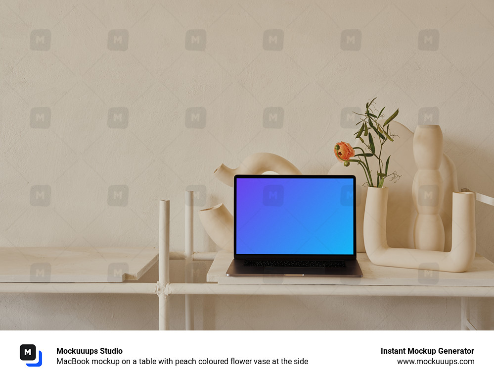 MacBook mockup on a table with peach coloured flower vase at the side