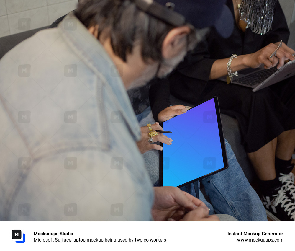 Microsoft Surface laptop mockup being used by two co-workers