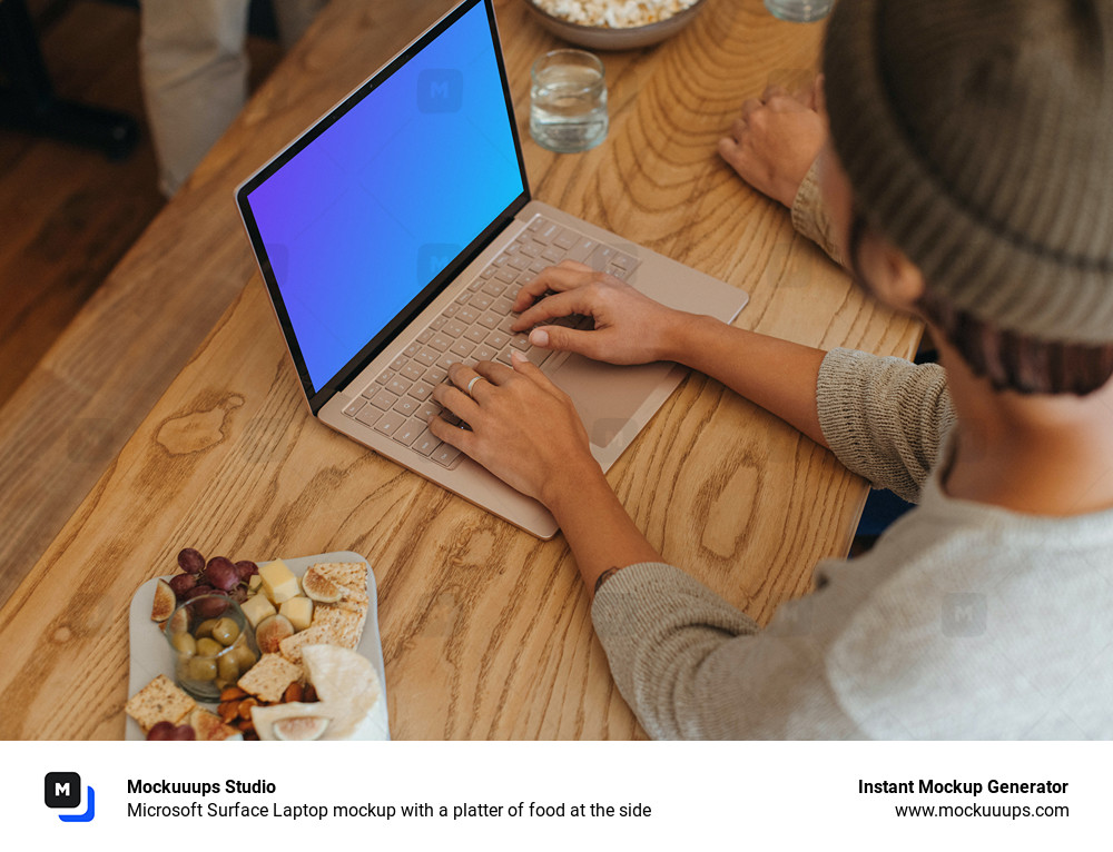 Microsoft Surface Laptop mockup with a platter of food at the side