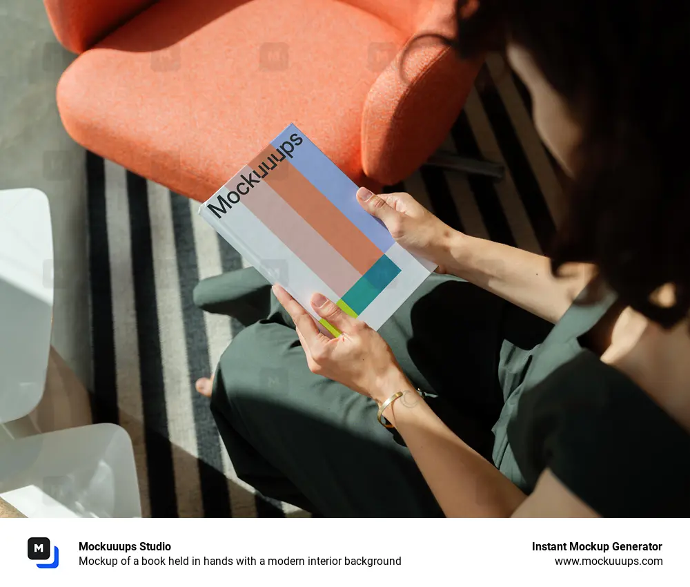 Mockup of a book held in hands with a modern interior background