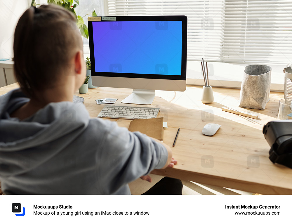 Mockup of a young girl using an iMac close to a window