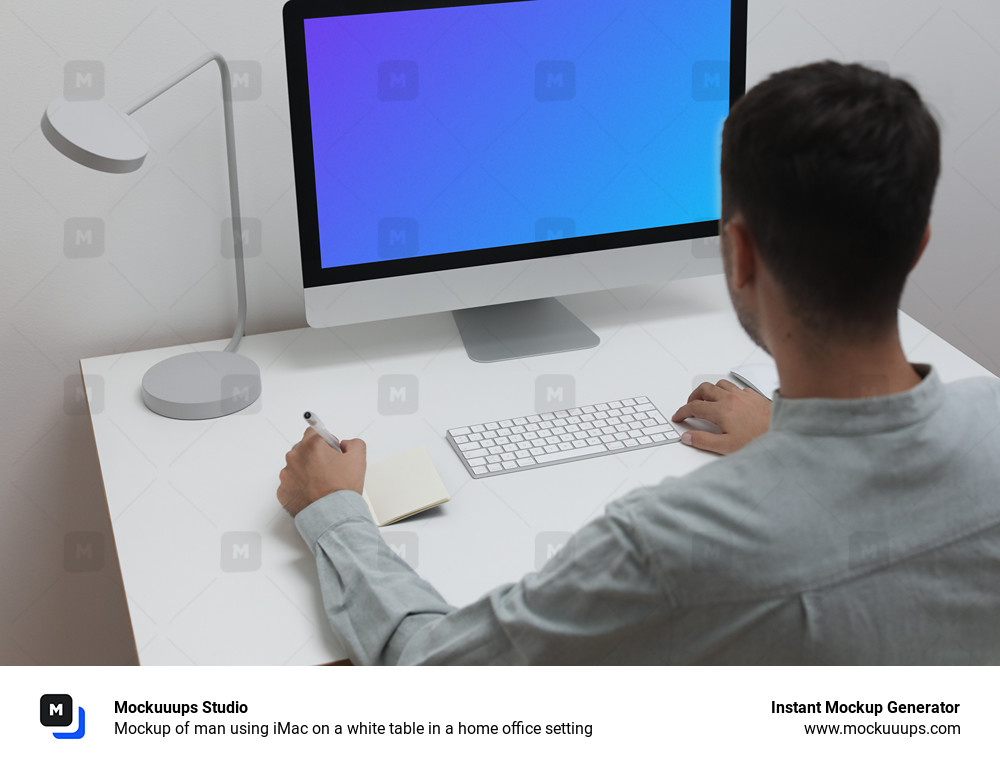 Mockup of man using iMac on a white table in a home office setting