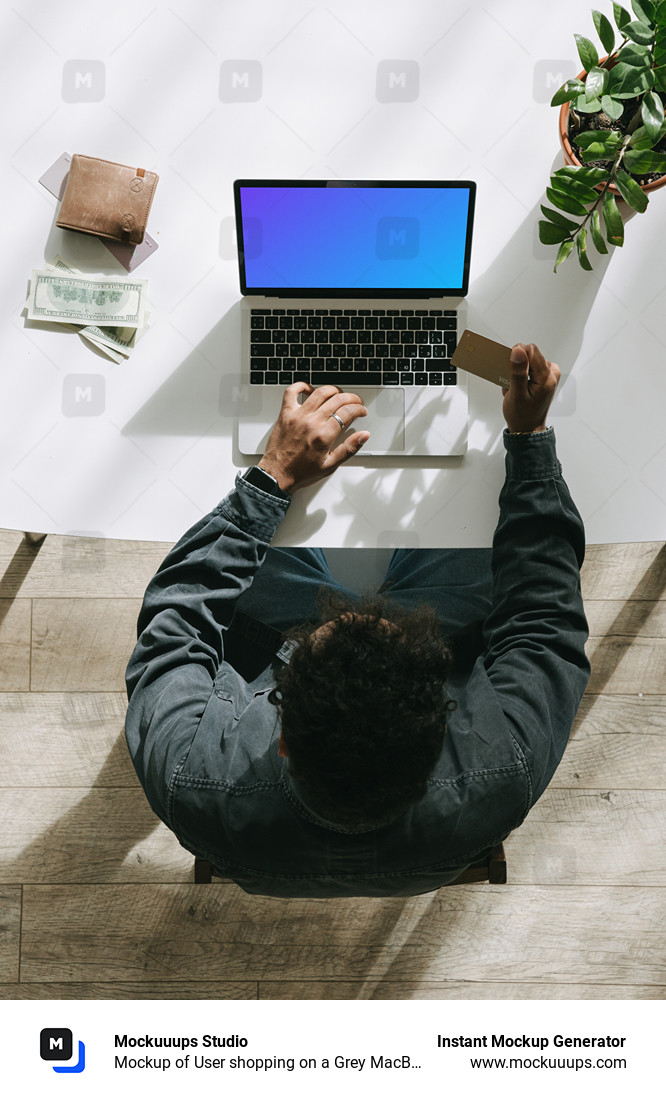 Mockup of User shopping on a Grey MacBook beside some cash and a wallet