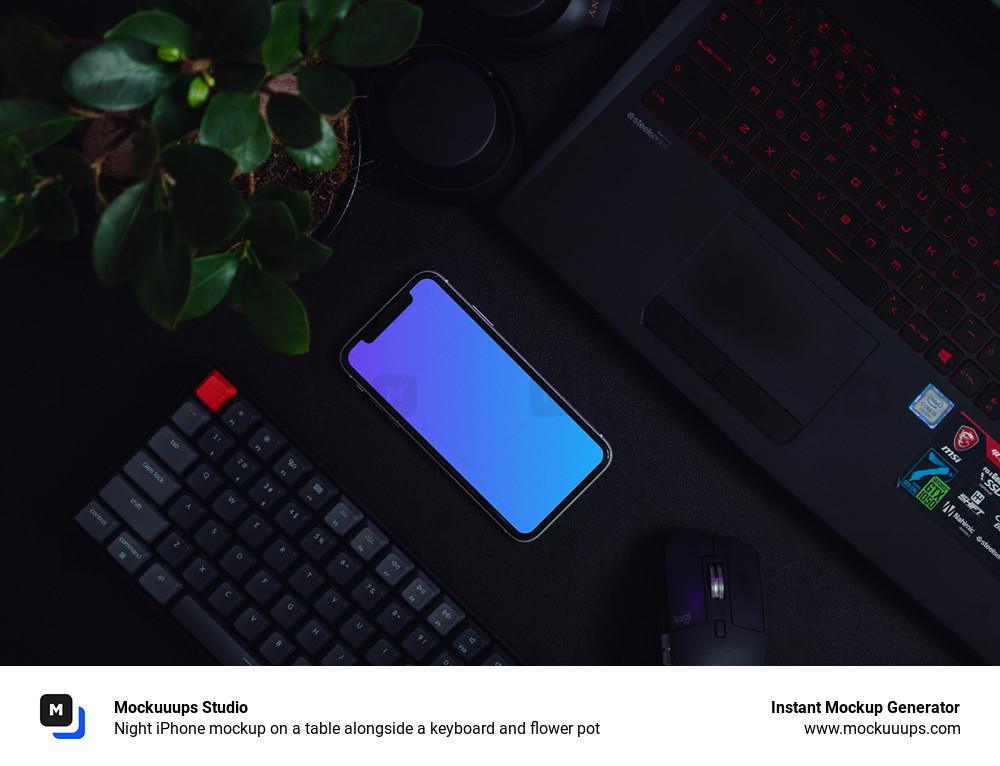 Night iPhone mockup on a table alongside a keyboard and flower pot