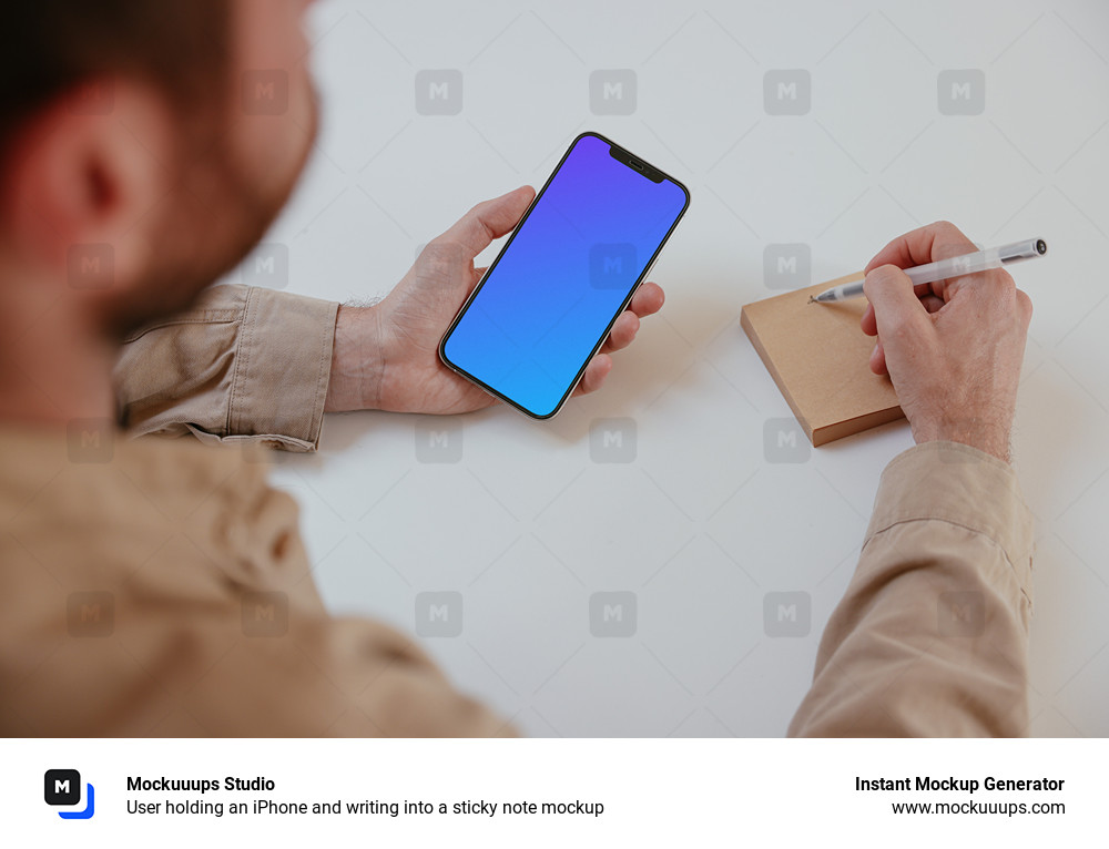 User holding an iPhone and writing into a sticky note mockup