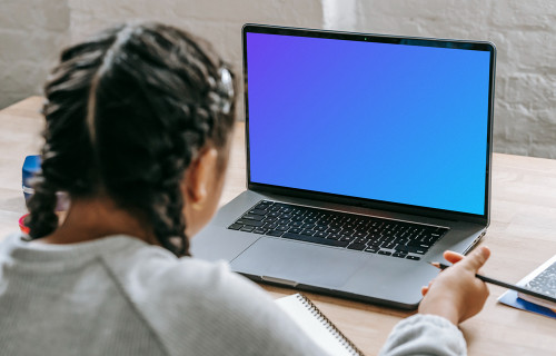 Young girl studying with a MacBook Pro mockup