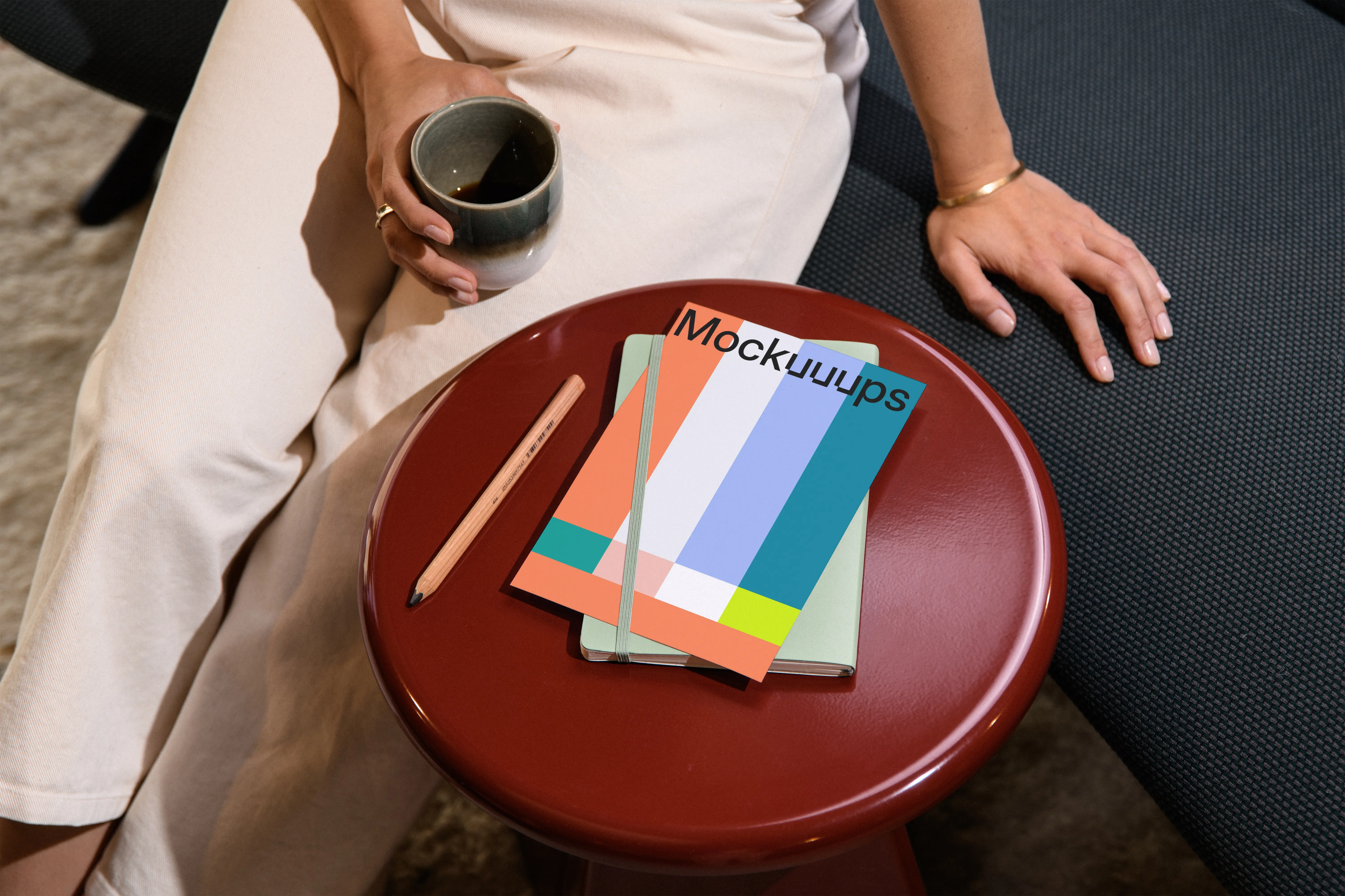 A4 paper mockup on a red round side table