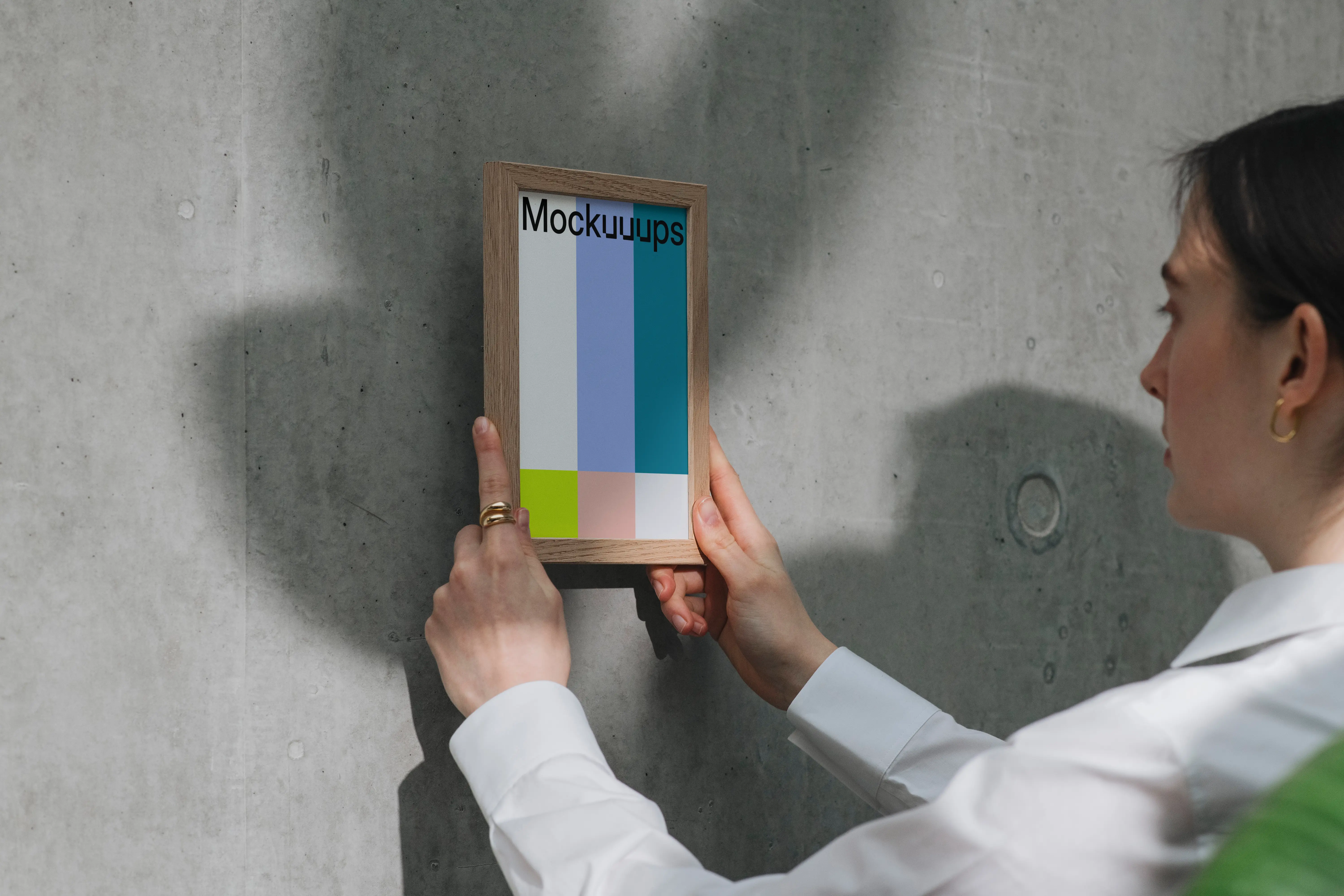 A5 mockup in wooden frame against concrete wall
