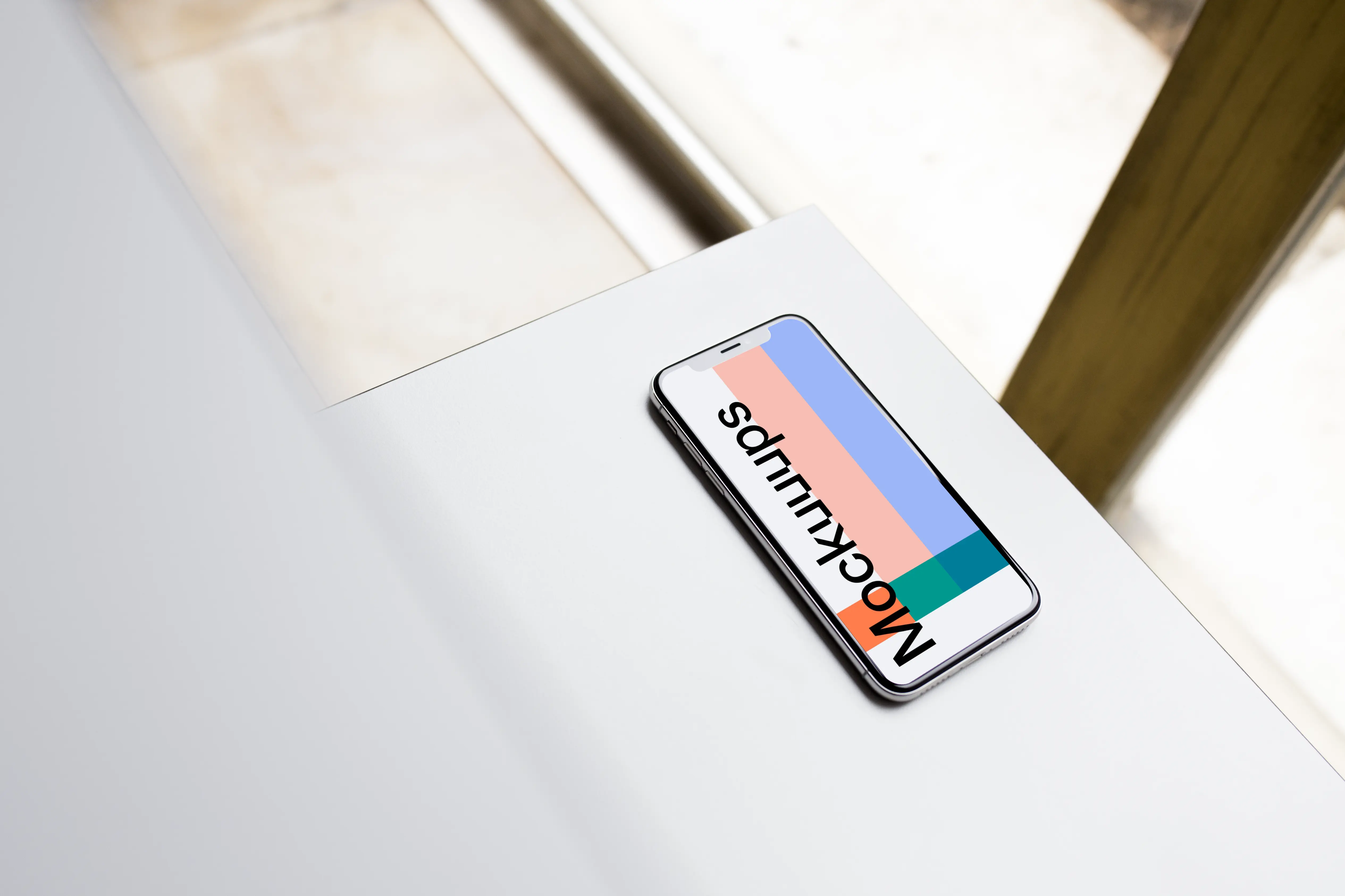 Angle view of iPhone X mockup on the table