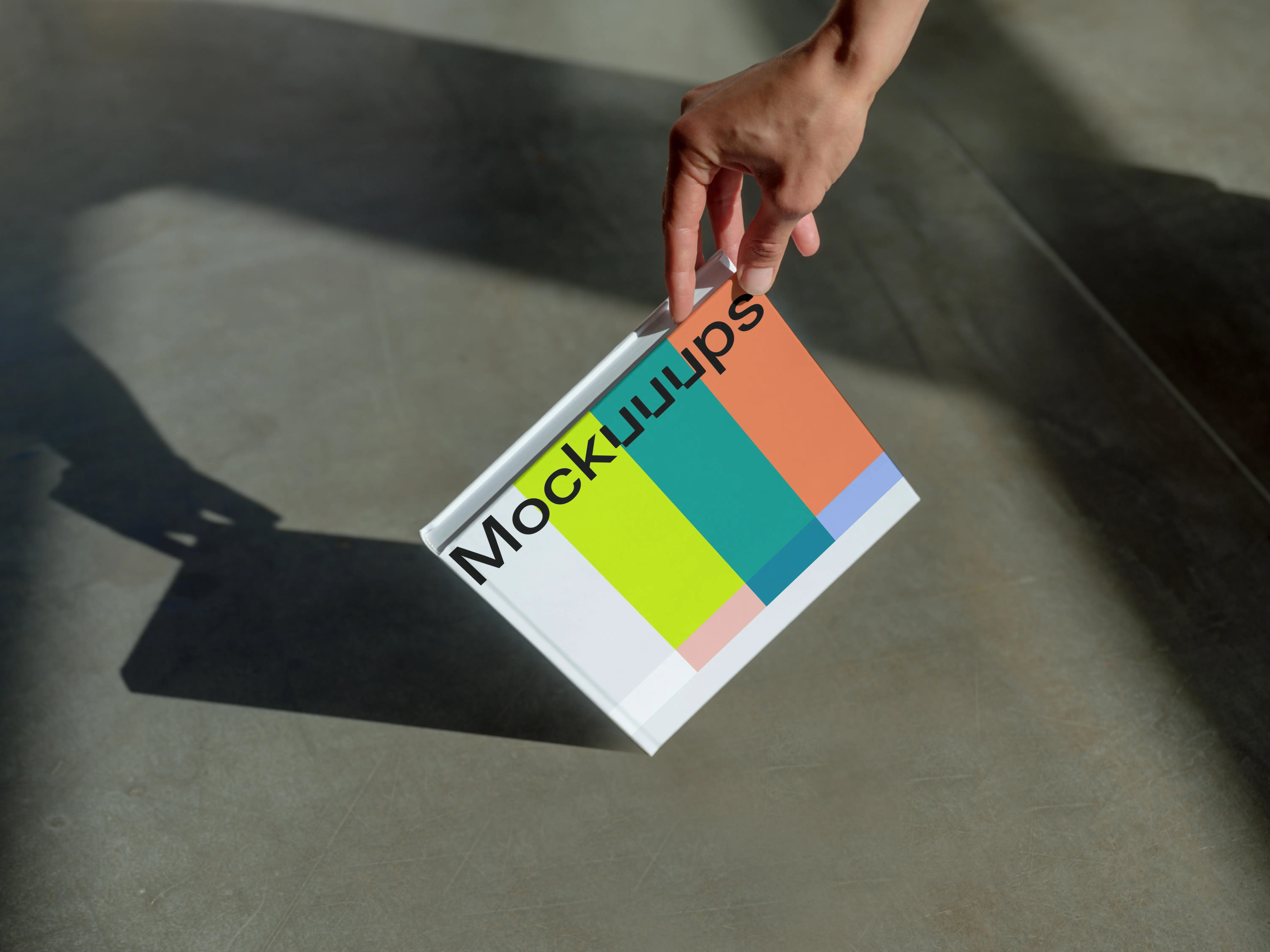 Book mockup with a gradient cover and hand detail