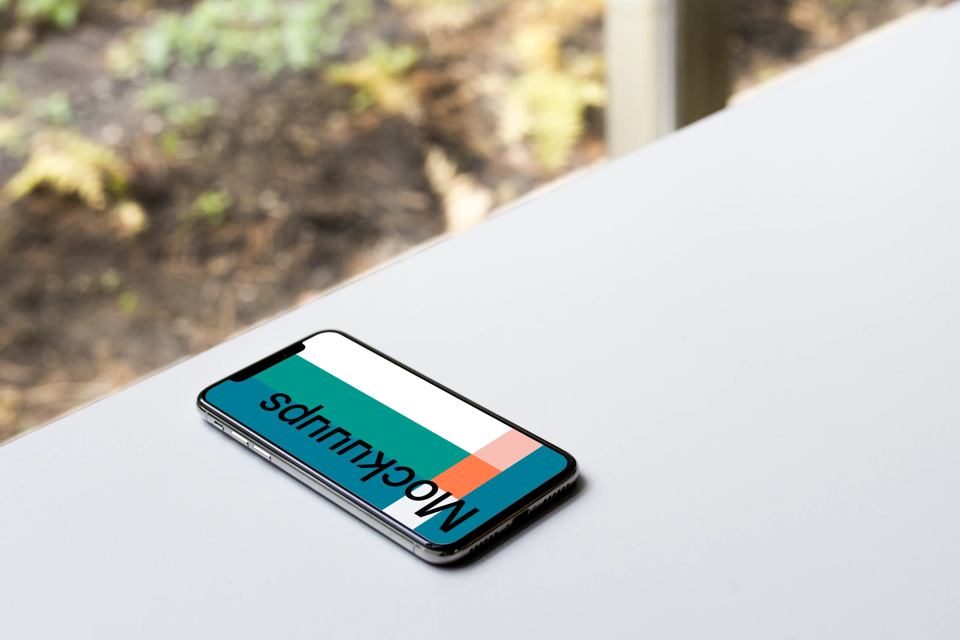 Bright view of iPhone X mockup on the table