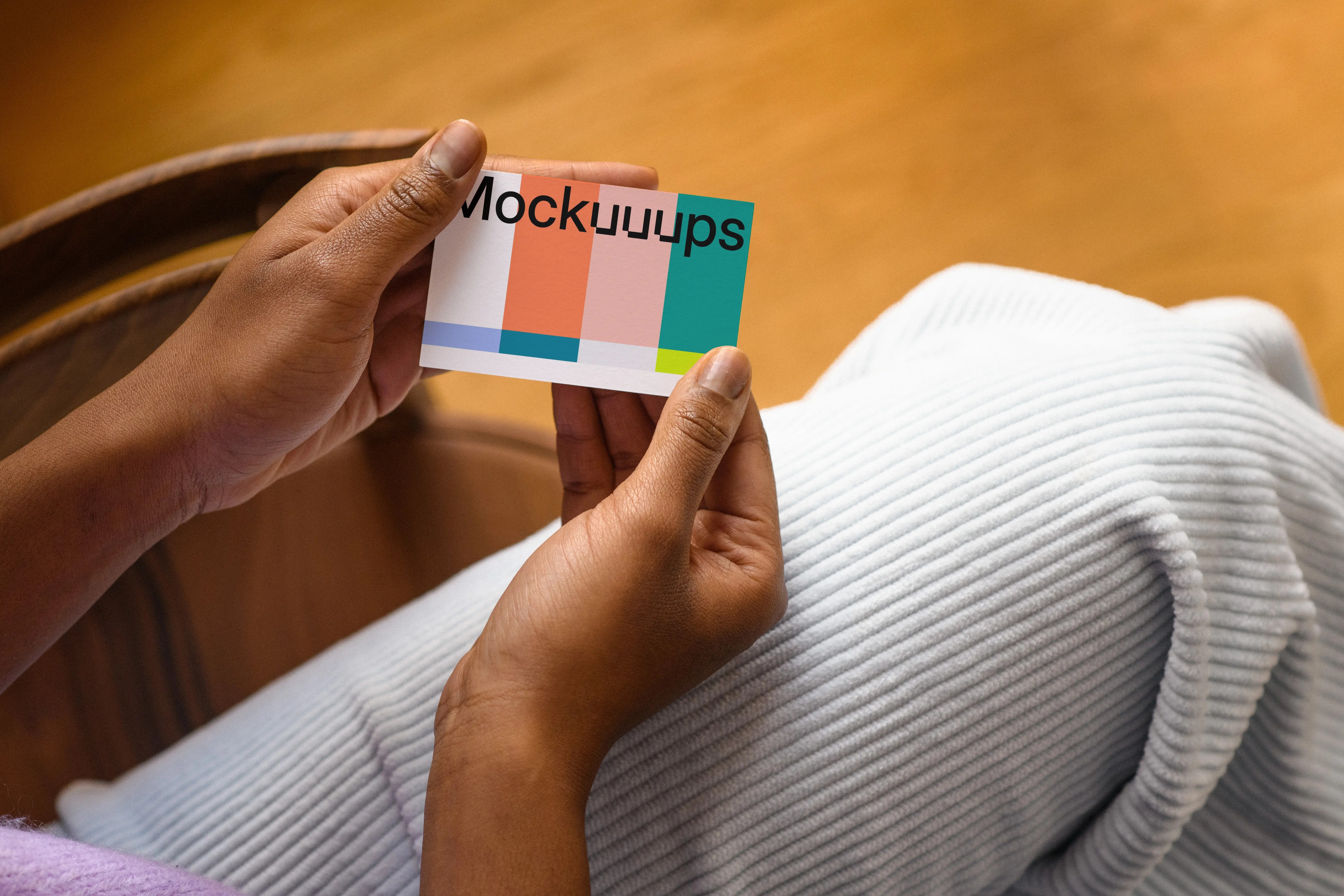 Business card mockup held by hands in a casual setting