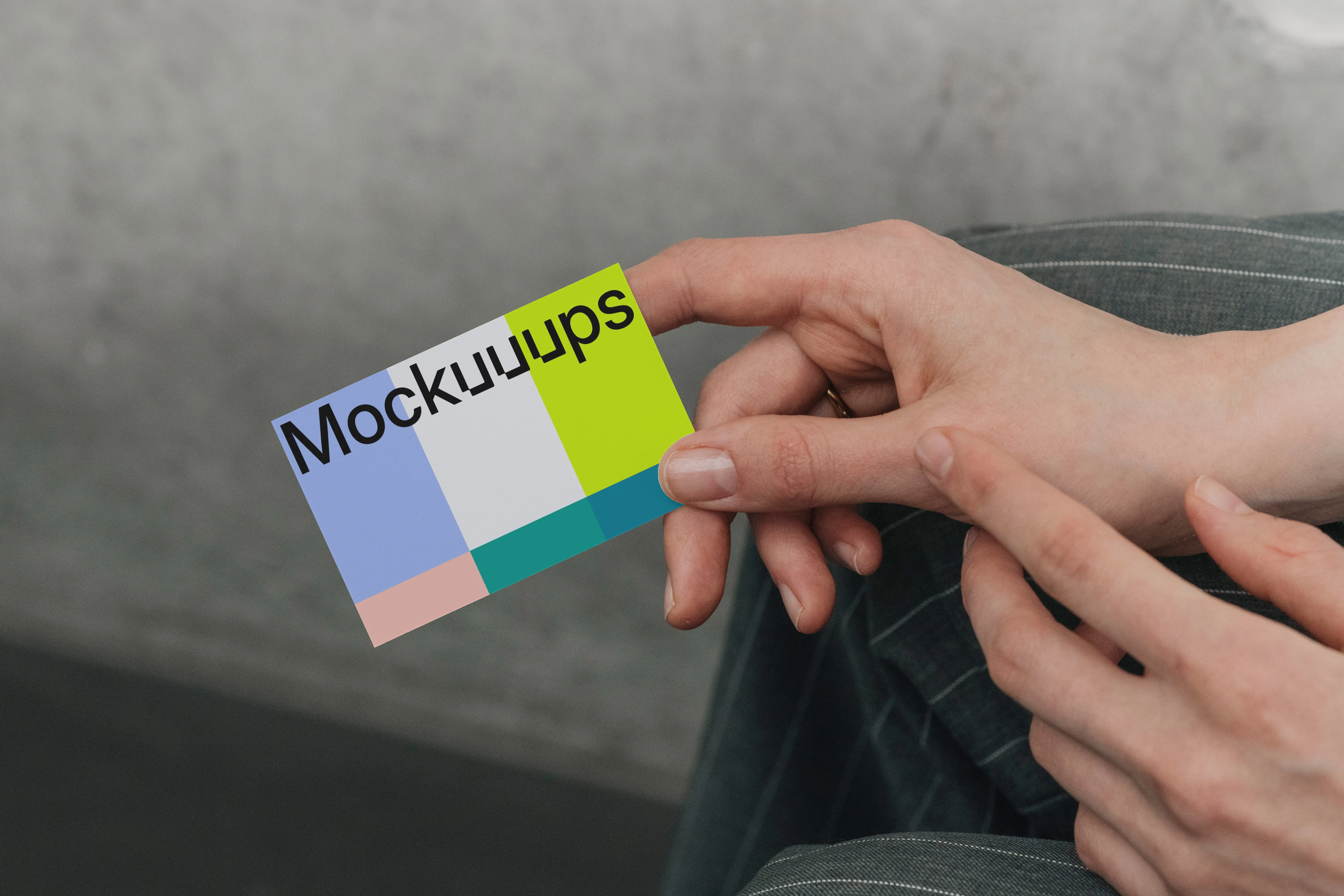 Business card mockup in hands against neutral background